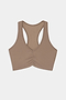 The SPLITS59 Airweight Bra With Ruching in Lentil is a beige racerback sports bra featuring ruched detailing at the front, crafted from a soft nylon and spandex blend, and displayed on a plain white background.