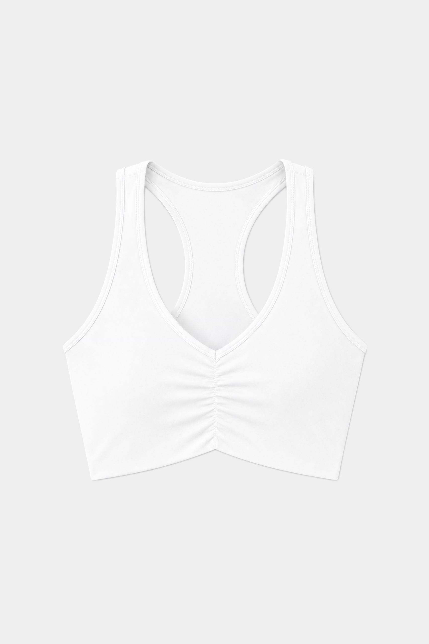 The SPLITS59 Airweight Bra with Ruching in white, made from lightweight performance fabric ideal for hot yoga, is shown against a plain light gray background.