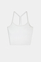 The SPLITS59 Airweight Crop - White is a racerback tank top with spaghetti straps, ideal for hot yoga, shown on a white background.