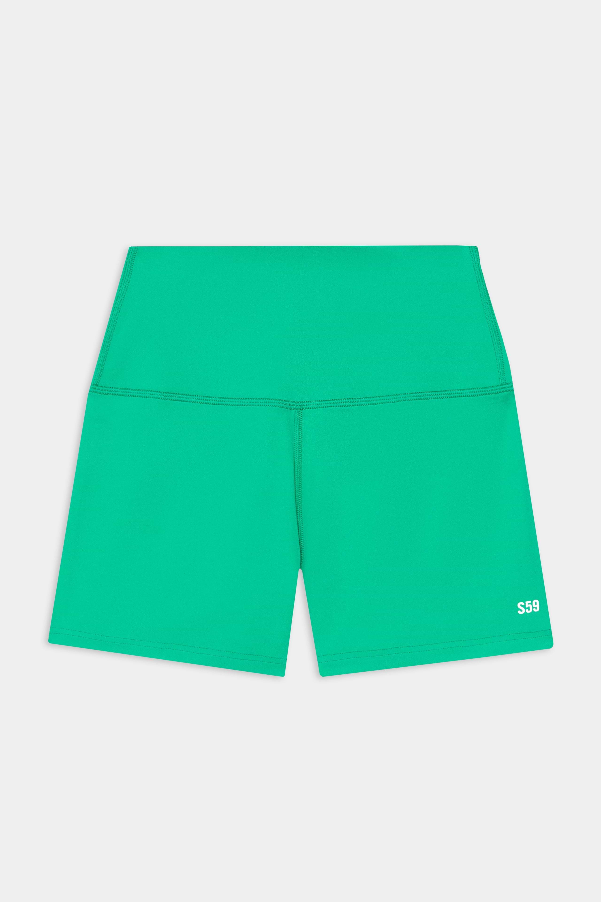 The SPLITS59 Airweight High Waist 3.5” Short in Spearmint features a green, fitted design in a smooth nylon-spandex blend with a small white "S59" logo on the lower left leg.