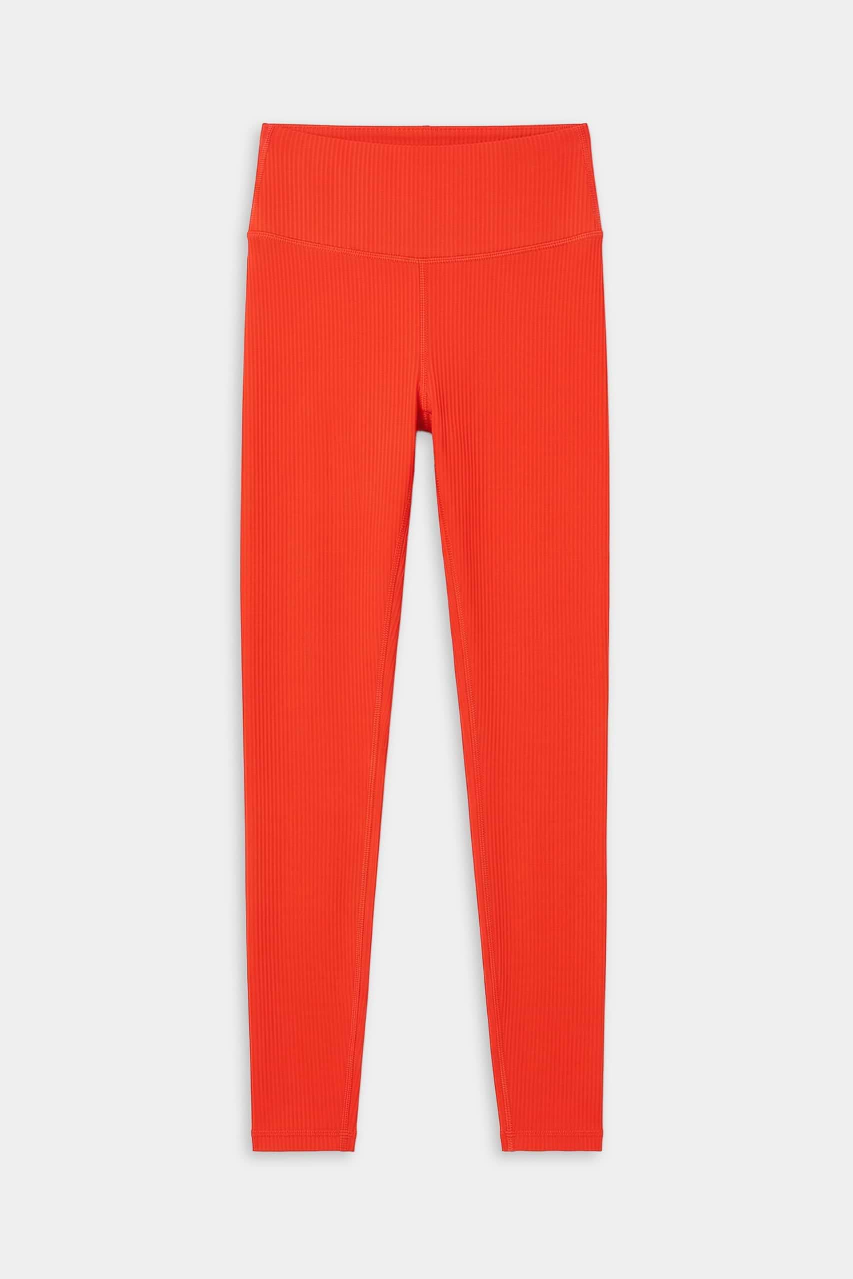 The SPLITS59 Airweight Rib High Waist 7/8 leggings in Lotus Red, featuring a ribbed texture and high waistband, are ideal for Pilates or hot yoga and are displayed flat on a white background.
