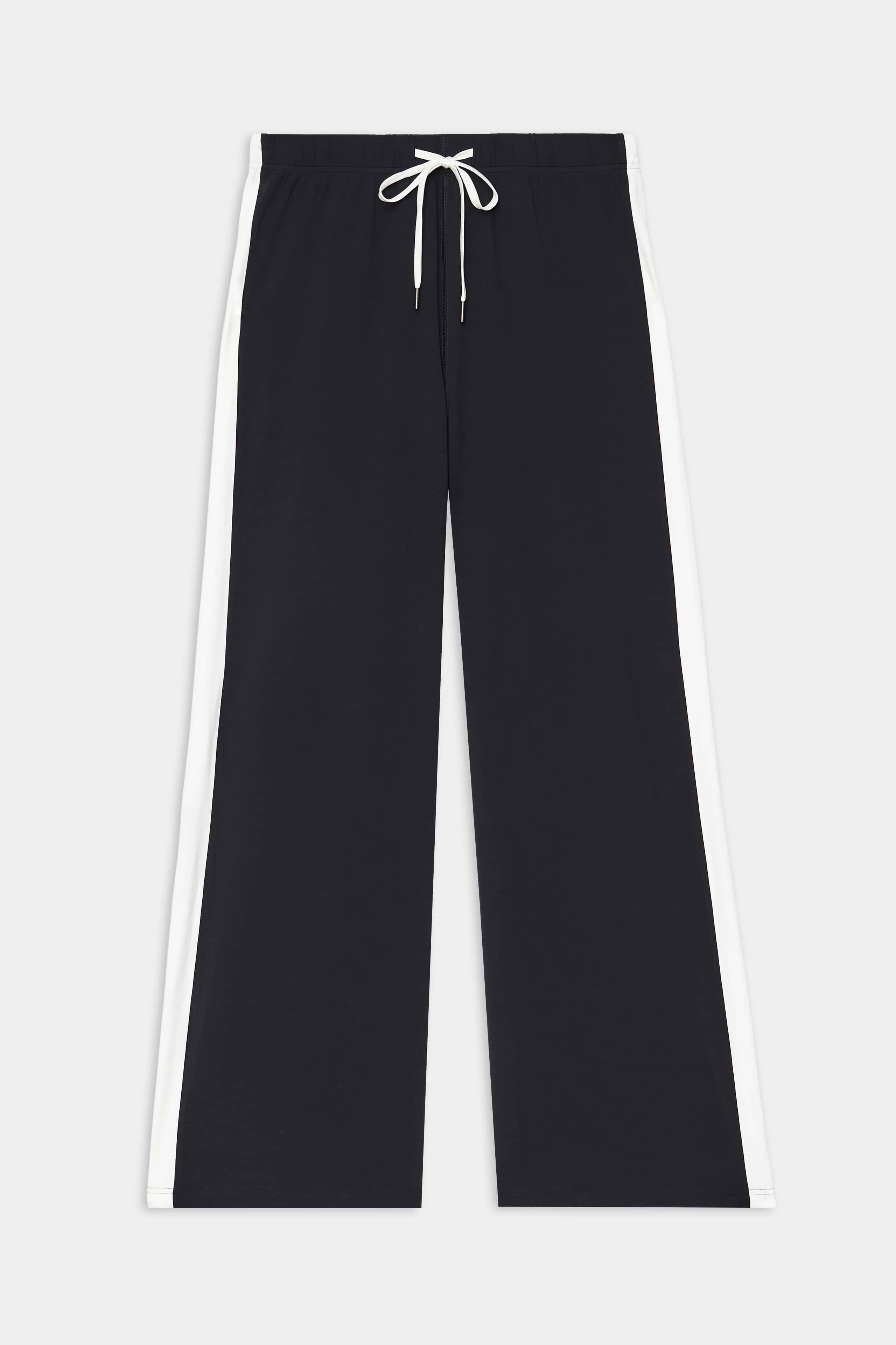The SPLITS59 Willow Airweight Wide Leg - Black/White features white side stripes and a white drawstring at the elastic waist, crafted from buttery-soft fabric and shown on a plain background.