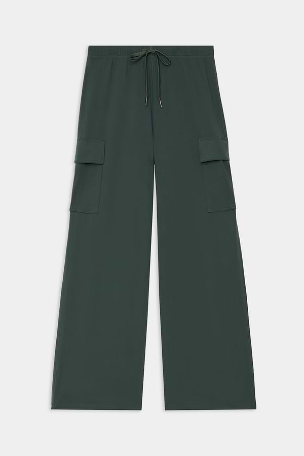 The SPLITS59 Alex Airweight Cargo Pant - Military features dark green wide-leg nylon-spandex fabric, an elastic drawstring waistband, and large side pocket flaps, displayed flat on a white background.