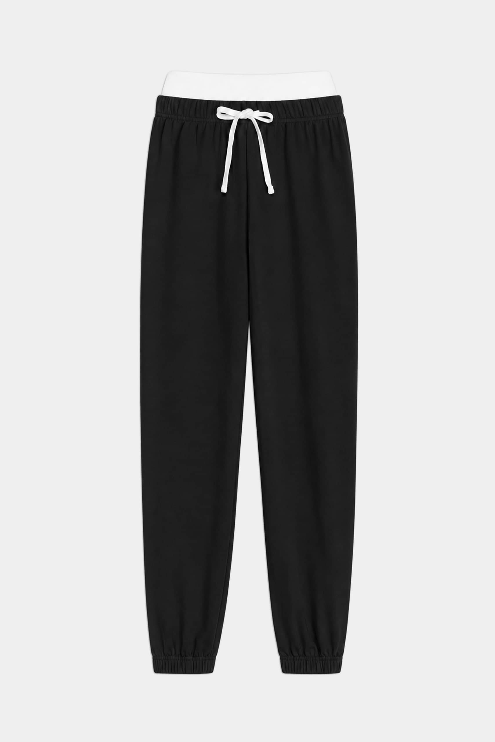 The SPLITS59 Andie Dual Waist Sweatpant in Black/White features a comfortable modal spandex blend, elastic waistband, white drawstring, and elastic cuffs, shown against a plain white background.