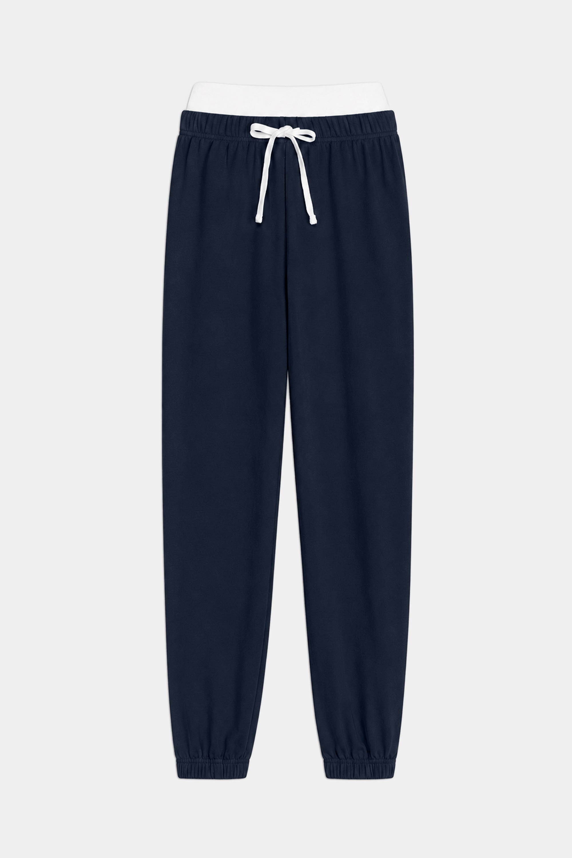 The SPLITS59 Andie Dual Waist Sweatpant in Indigo/White is crafted from ultra-luxe fleece with an elastic waistband, white drawstring, and elastic cuffs, shown laid flat on a white background. Made in Los Angeles.