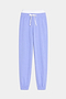 The SPLITS59 Andie Dual Waist Sweatpant in Purple Haze/White features soft modal fabric, a white drawstring, elastic waistband, and ankle cuffs, shown against a plain white background.