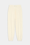 The Andie Oversized Fleece Sweatpant - Creme by SPLITS59 features an elastic waistband, drawstring, and cuffs—perfect for cool weather workouts. Displayed on a plain light background.