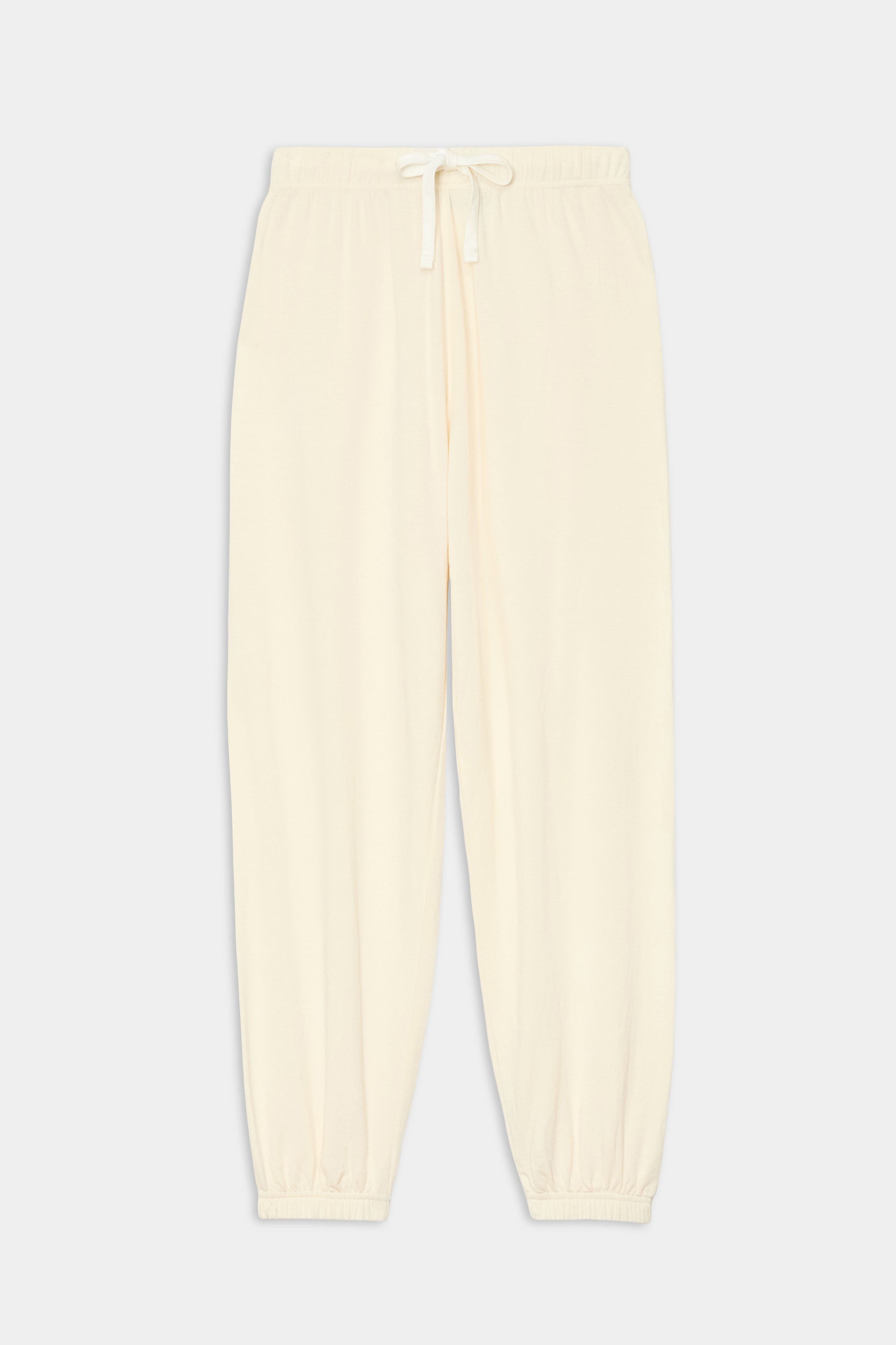 The Andie Oversized Fleece Sweatpant - Creme by SPLITS59 features an elastic waistband, drawstring, and cuffs—perfect for cool weather workouts. Displayed on a plain light background.