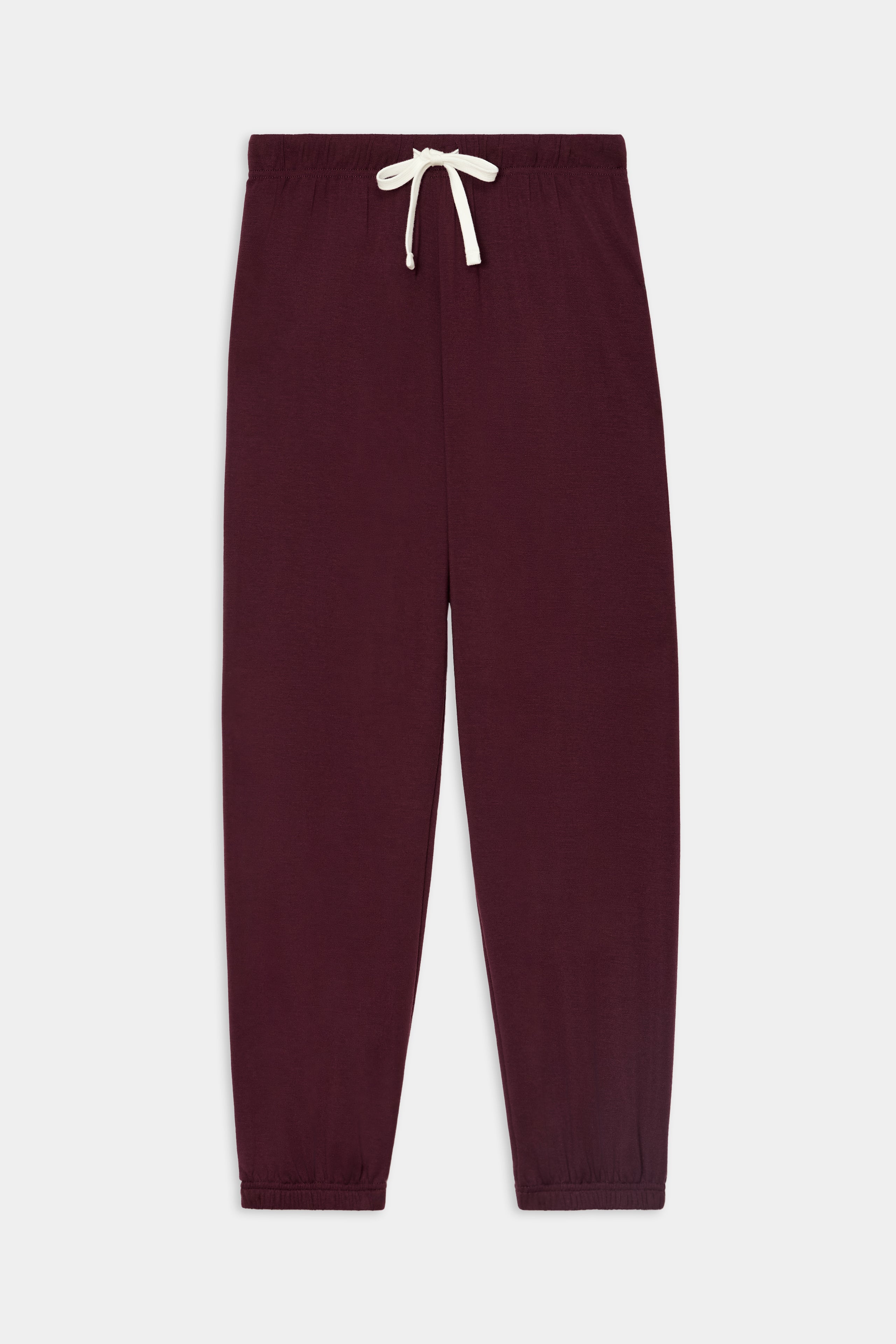 The SPLITS59 Andie Oversized Fleece Sweatpant in Dark Cherry features an elastic waistband, white drawstring, and elastic cuffs. Laid flat on a white background, it’s perfect for cool weather workouts.