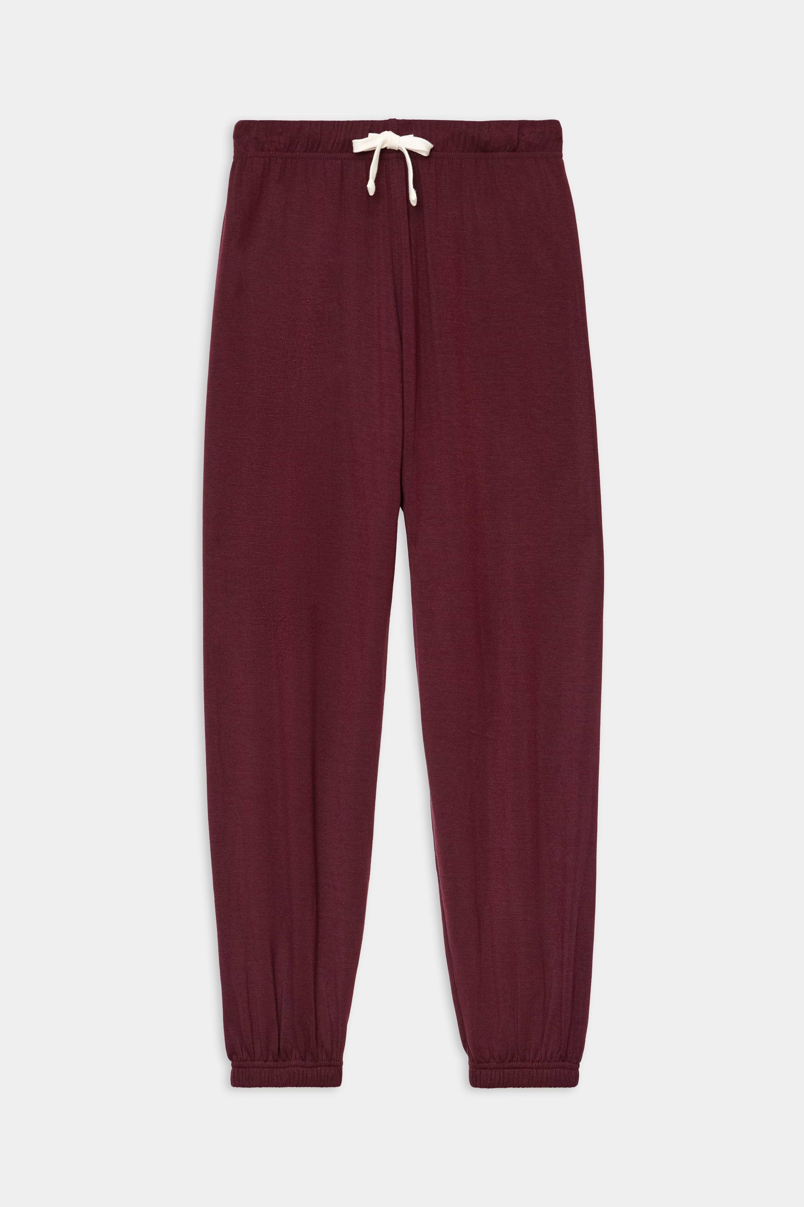 The SPLITS59 Andie Oversized Fleece Sweatpant in Dk Cherry features elastic cuffs and a white drawstring waistband, crafted from a stretchy spandex blend, shown laid flat on a white background.