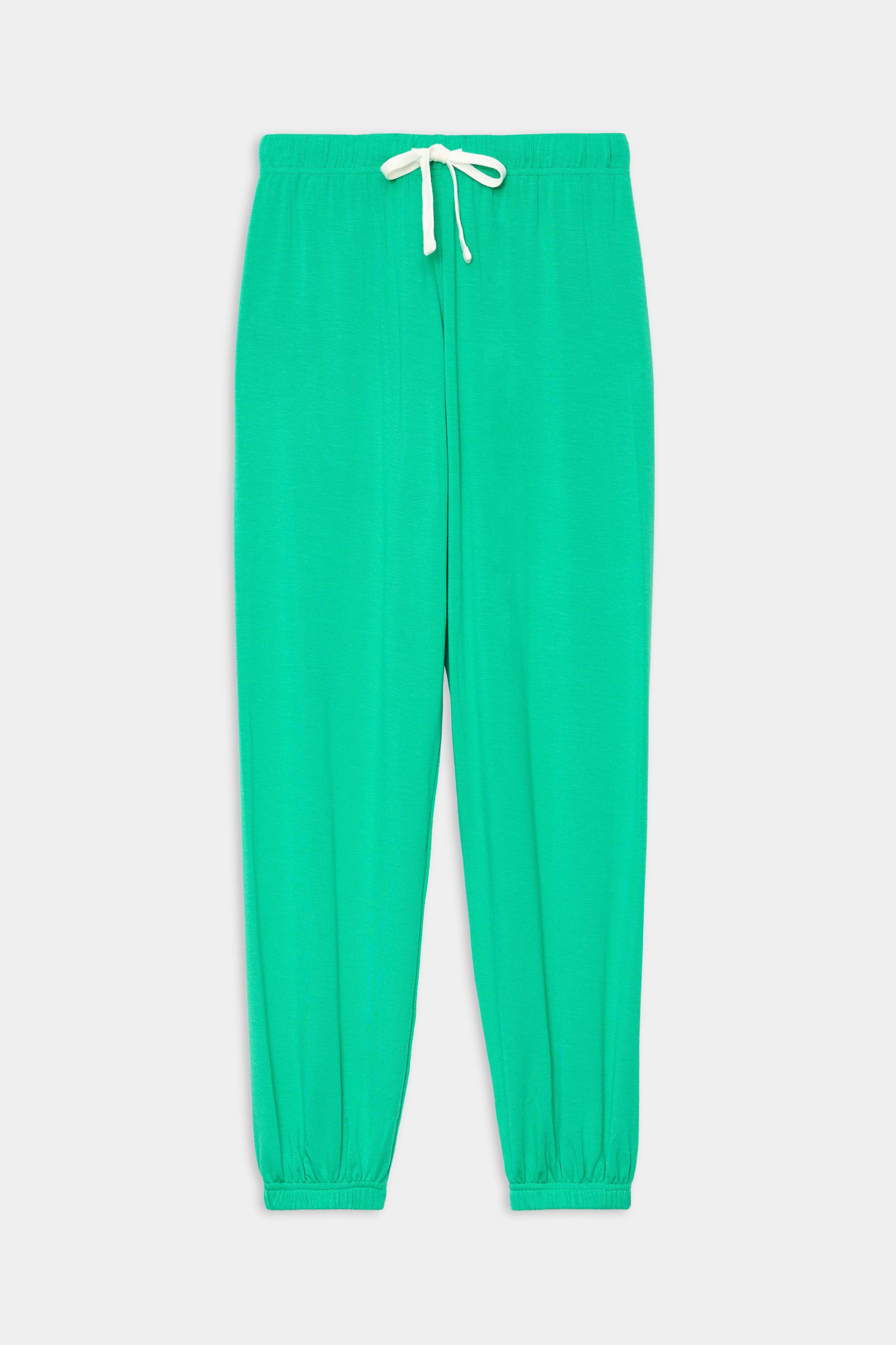 The SPLITS59 Andie Oversized Fleece Sweatpant in Spearmint features a cozy spandex blend, elastic waistband with a white drawstring, and elastic cuffs, shown laid flat on a white background.