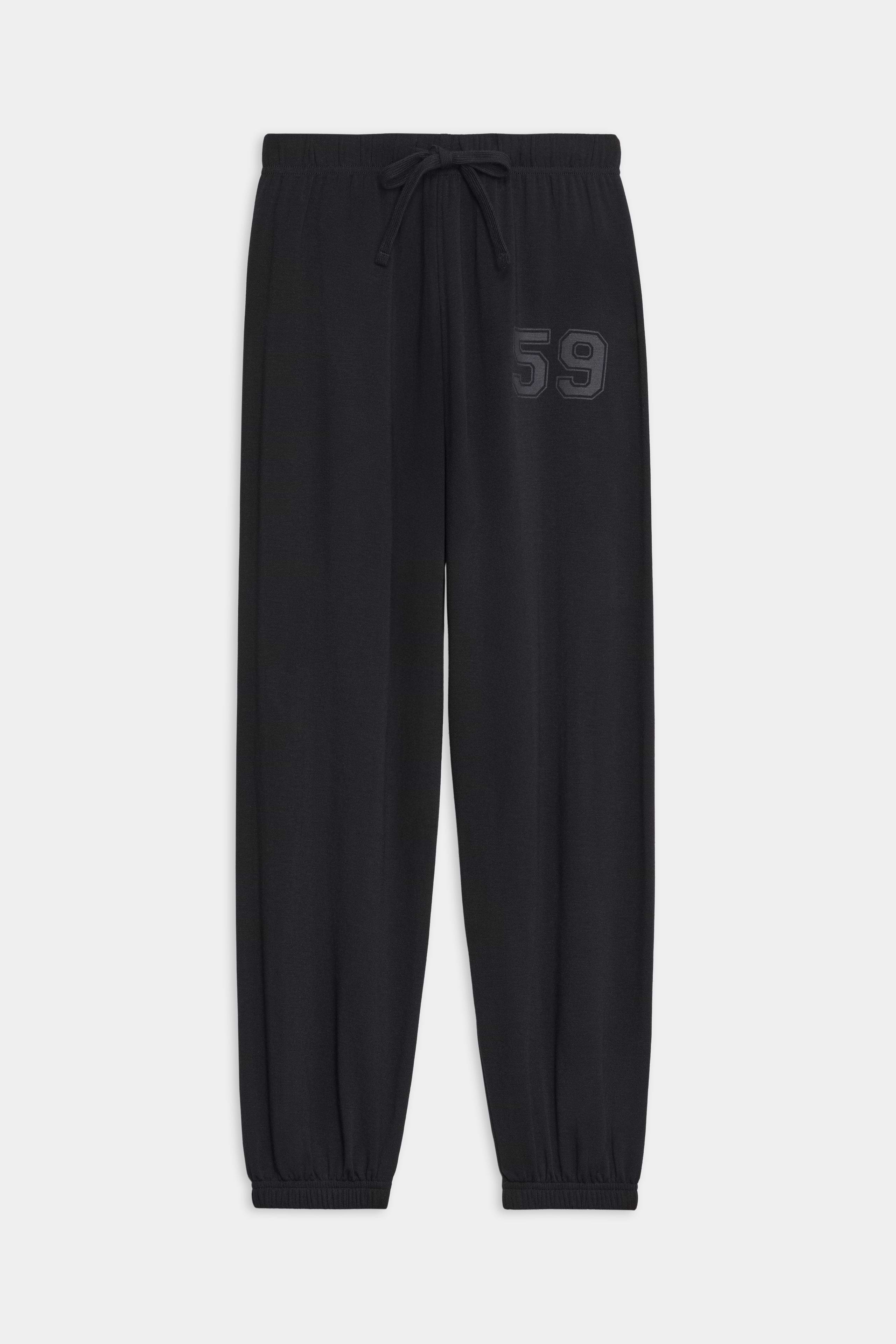 The SPLITS59 Andie Oversized Fleece Varsity 59 Sweatpant in Black features an elastic waistband, adjustable drawstring, elastic cuffs, and "59" embroidery—crafted in Los Angeles for cool weather workouts.