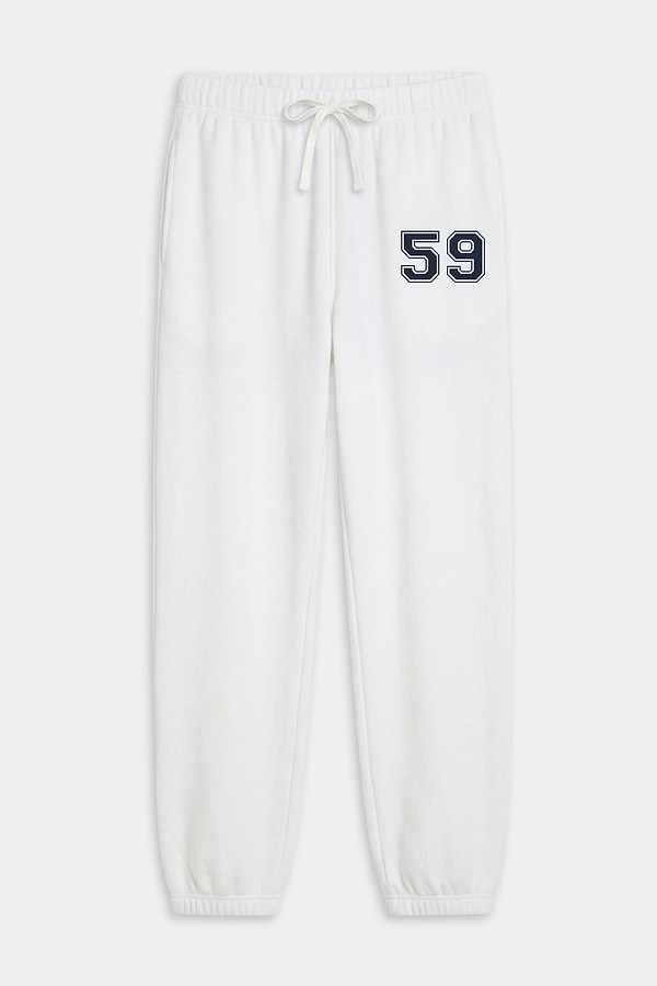 The SPLITS59 Andie Oversized Fleece Varsity 59 Sweatpant in White features an elastic waistband, drawstring, and cuffs, plus a dark "59" on the left thigh—ultra luxe and made in Los Angeles, perfect for cool weather workouts.