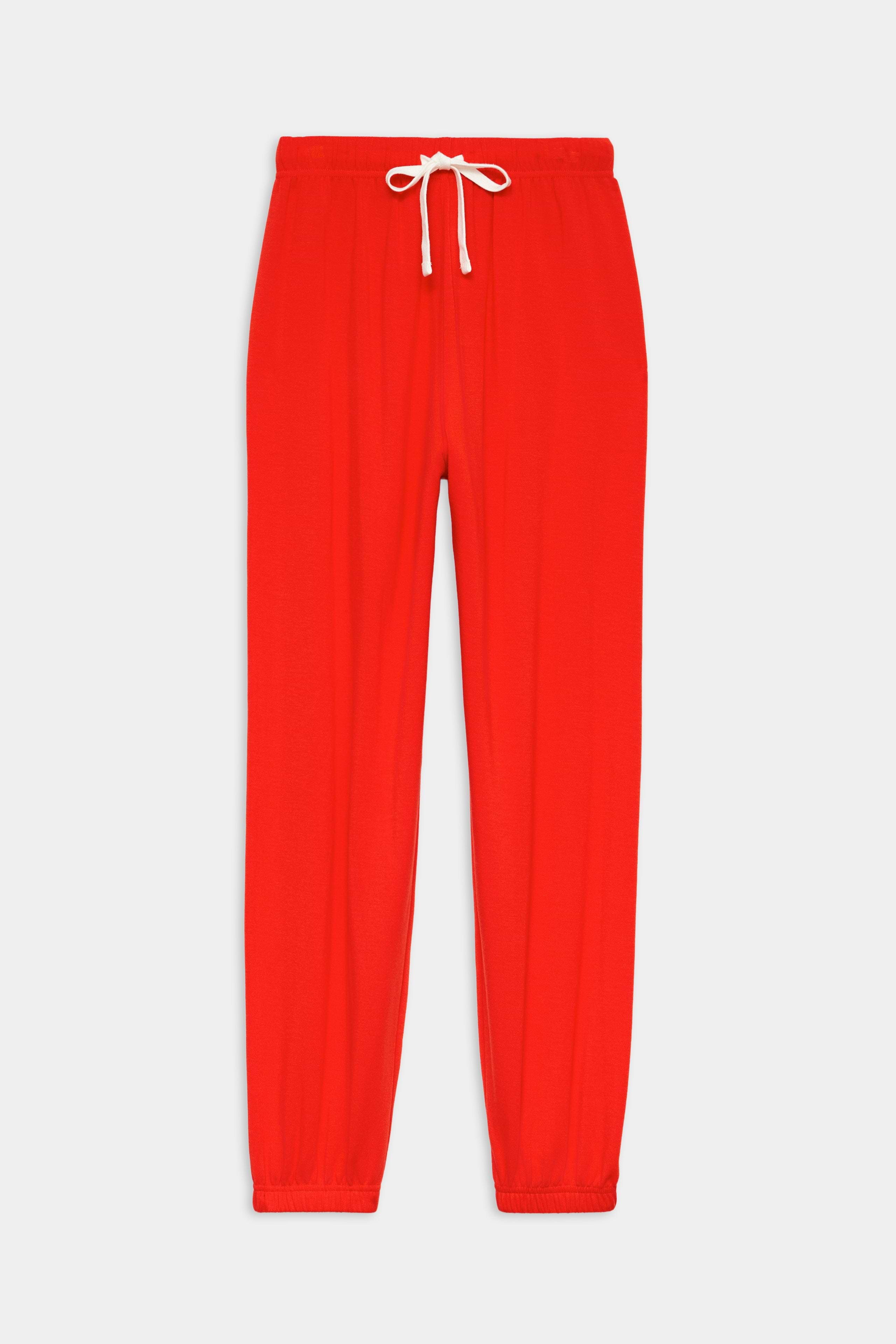 The SPLITS59 Andie Oversized Fleece Sweatpant in Lotus Red features an elastic waistband, white drawstring, and elastic cuffs—ideal for warm weather workouts. Proudly made in Los Angeles and shown flat on a white background.