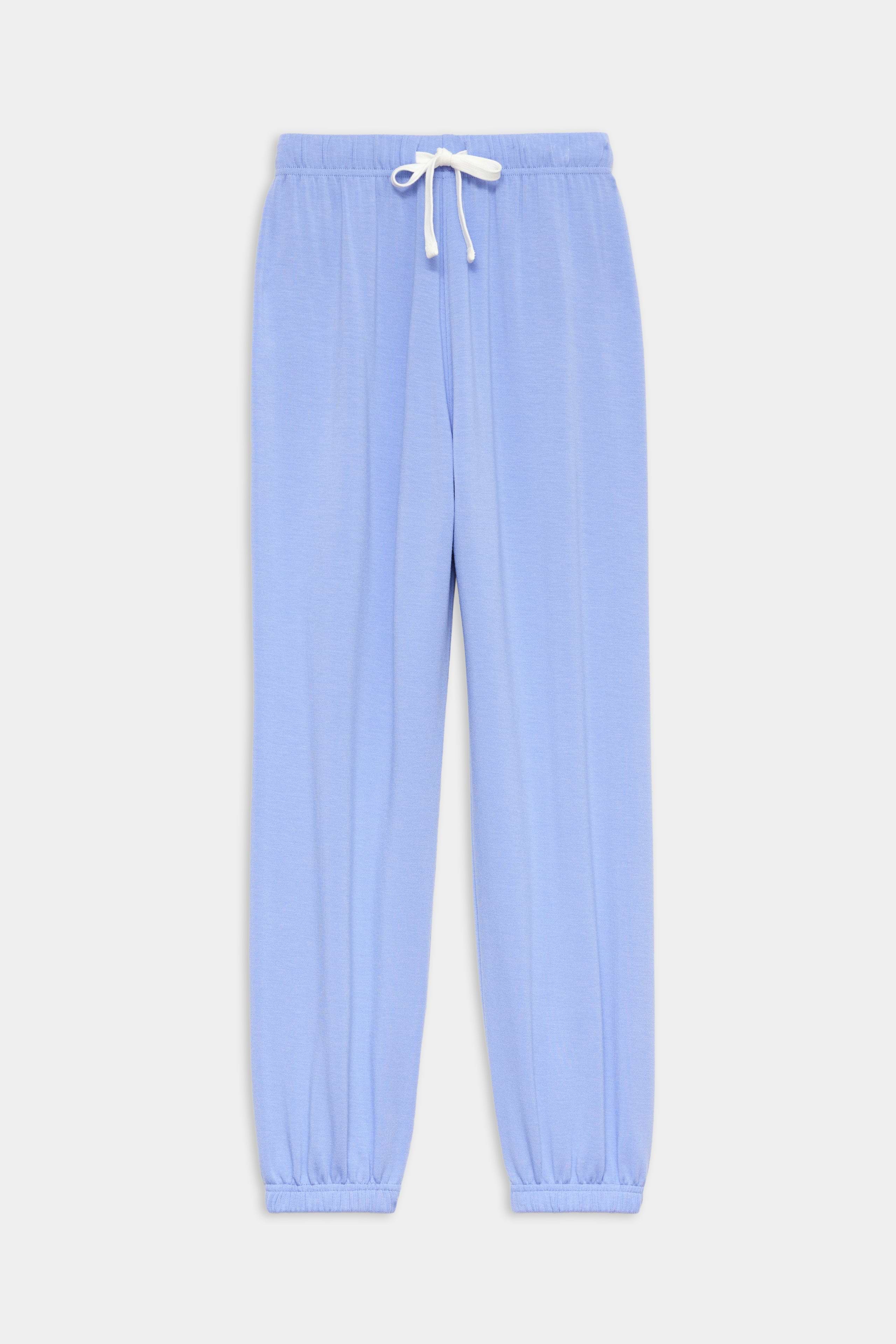 The SPLITS59 Andie Oversized Fleece Sweatpant in Purple Haze features a relaxed fit with a white drawstring waist and elastic ankle cuffs, perfect for warm weather workouts, shown against a plain white background.