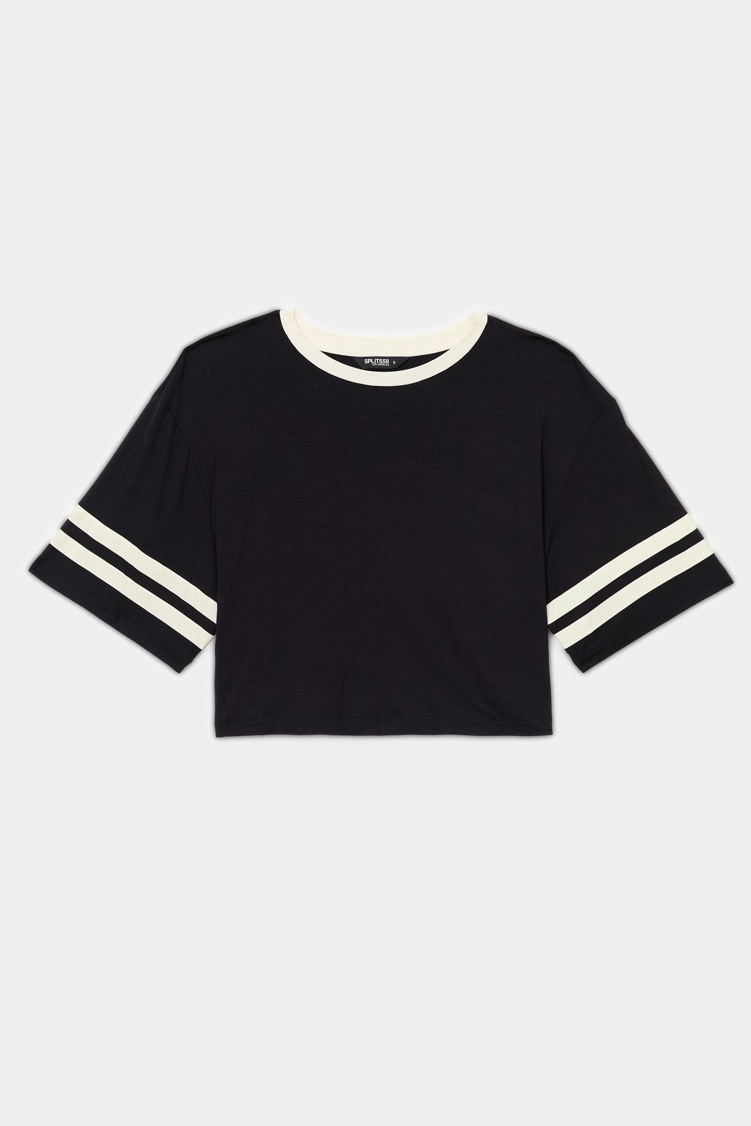 The SPLITS59 Djuna Oversized Crop Jersey Tee - Black/Creme features white collar and sleeve stripes and a stretchy fit, shown laid flat on a white background.