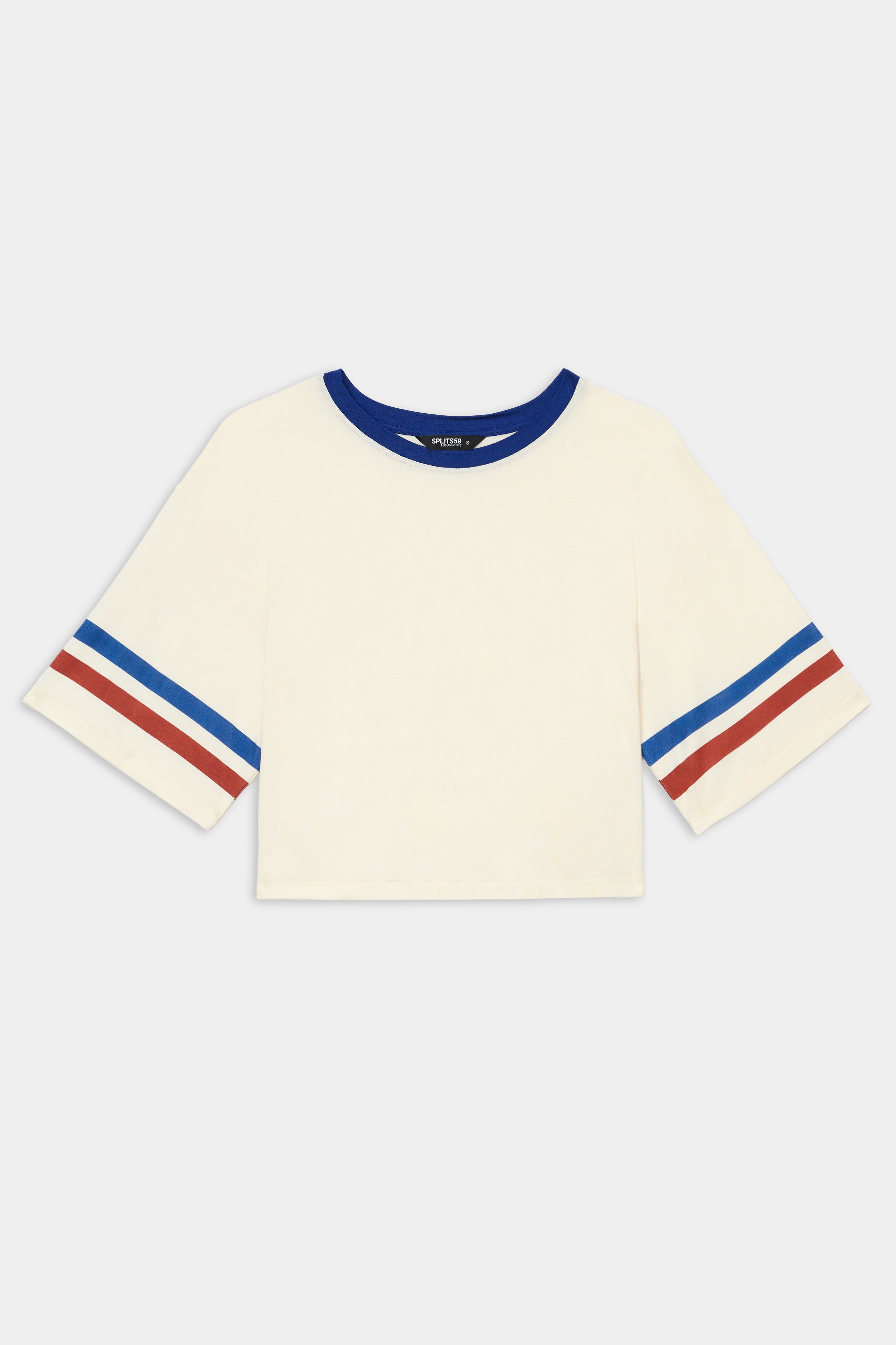 The Djuna Oversized Crop Jersey Tee - Creme/Cobalt by SPLITS59 features soft viscose, a blue collar, and blue/red striped sleeves, shown flat on a white background.