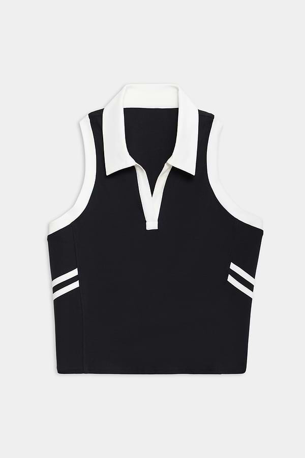 The SPLITS59 Austin Airweight Crop Polo is a sleeveless black top with a white collar, V-neck, and two white stripes near the hem on each side.