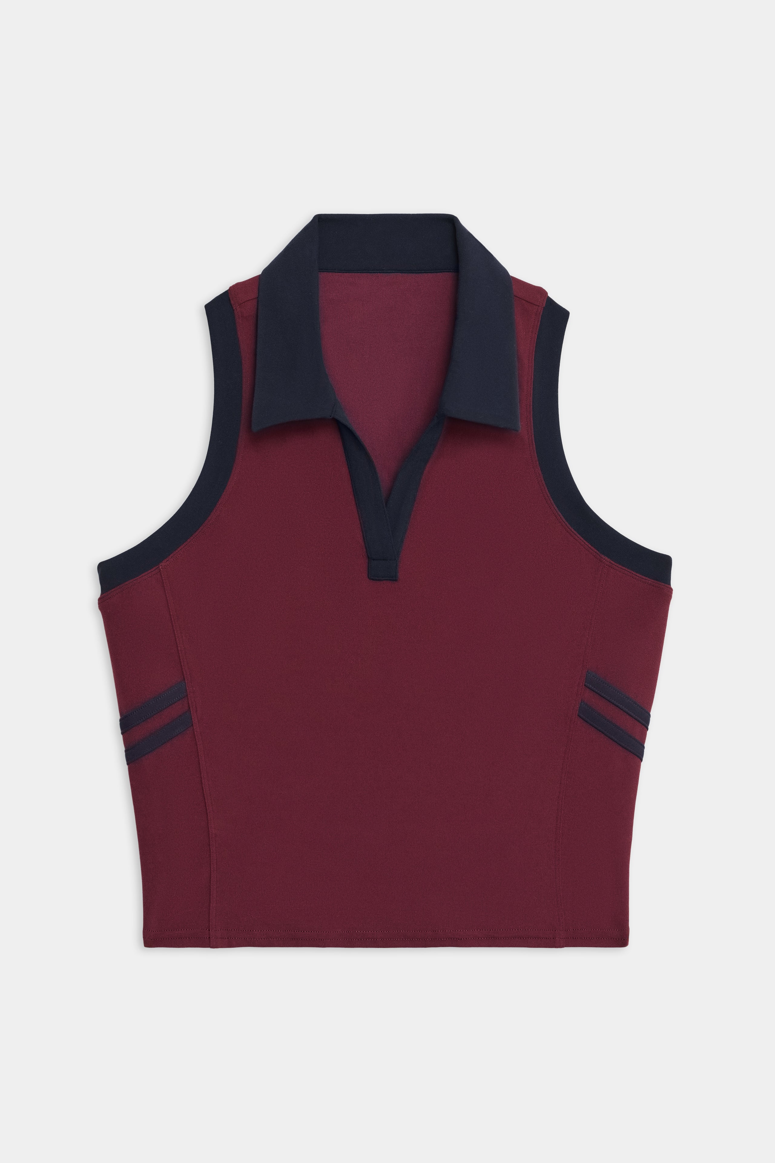 The SPLITS59 Austin Airweight Crop Polo is a sleeveless maroon knit top with a navy collar, trim, and two navy stripes on each armhole.