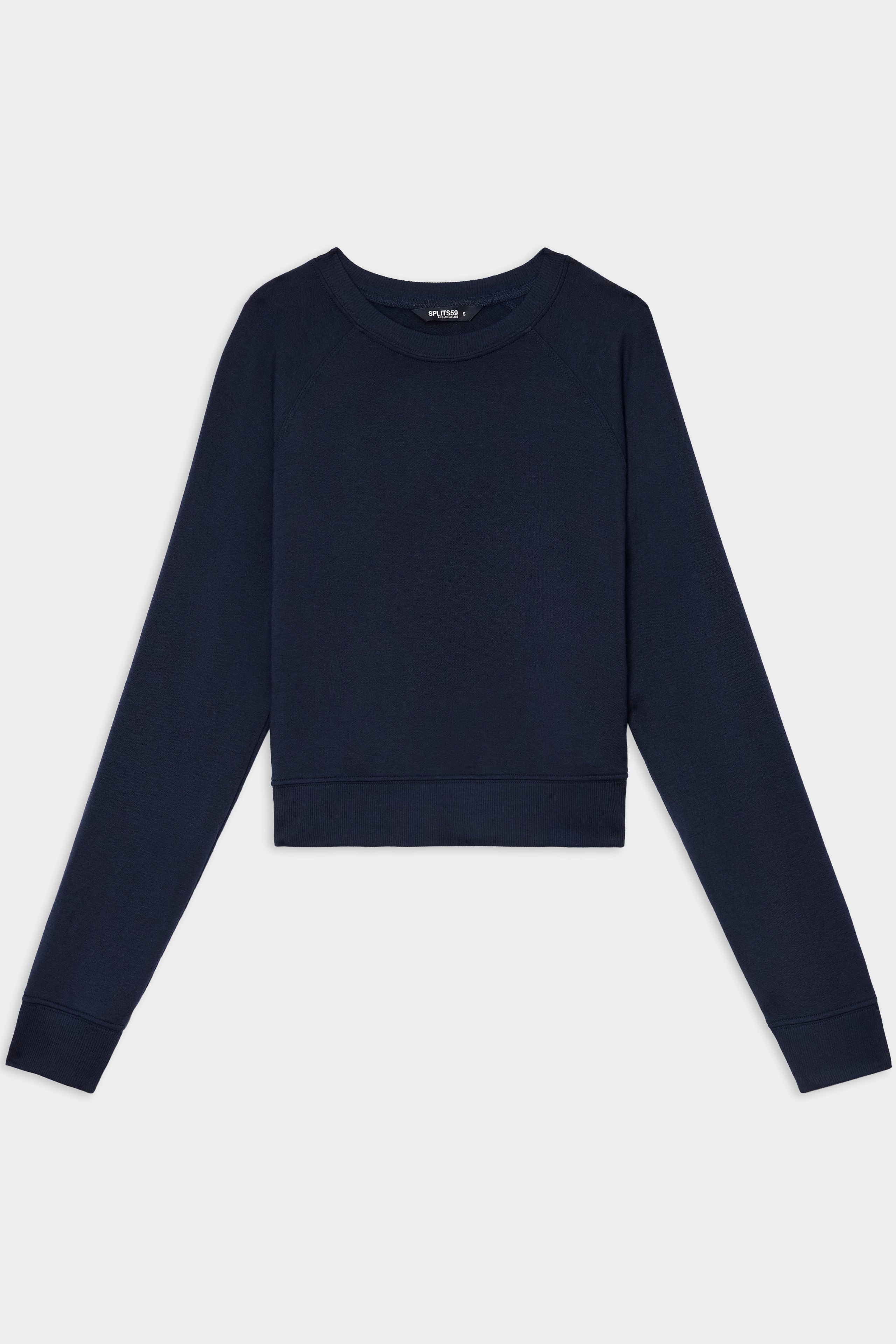 The SPLITS59 Brooks Fleece Long Sleeve Sweatshirt in Indigo features a cropped silhouette with long raglan sleeves and a crewneck, shown laid flat on a white background.