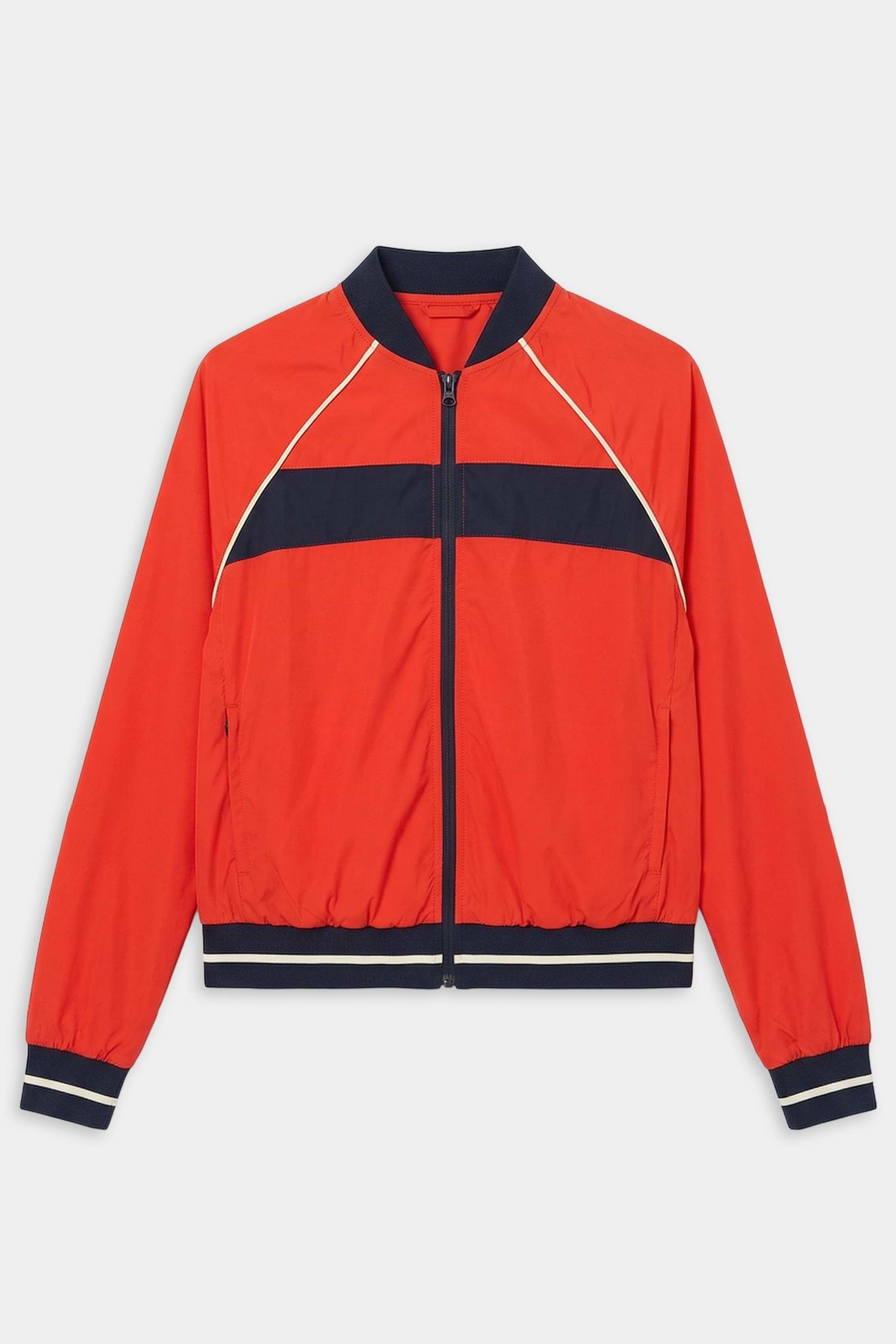 The SPLITS59 Carrie Woven Nylon Jacket in Lotus Red/Indigo features navy and white stripes, ribbed cuffs and waistband, two front pockets, and a comfy nylon-spandex blend, shown against a white background.