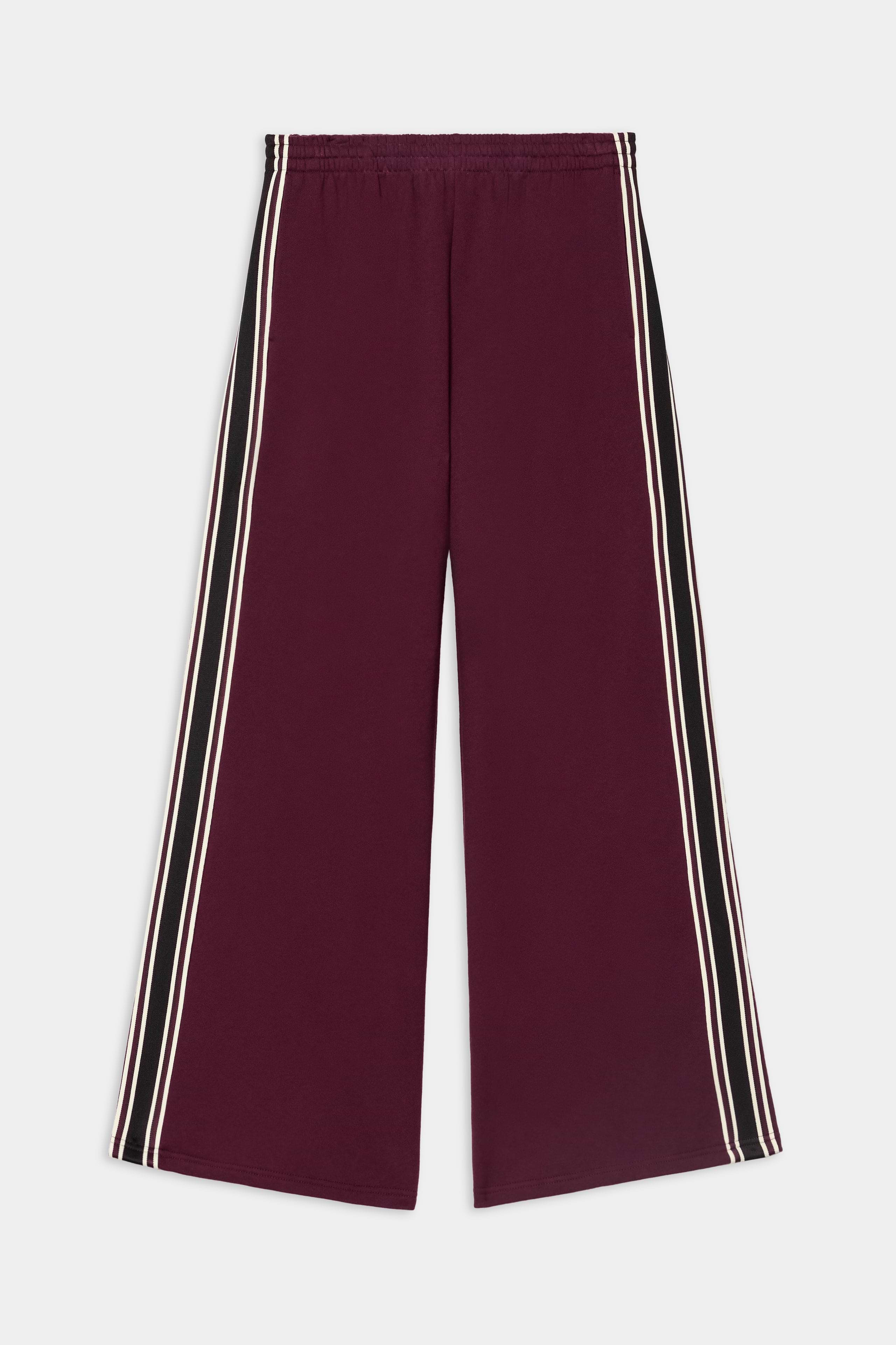The SPLITS59 Dallas French Terry Wide Leg Sweatpant in Dark Cherry/Black is crafted from 100% cotton, featuring black side panels and two white stripes running down each side, shown against a white background.
