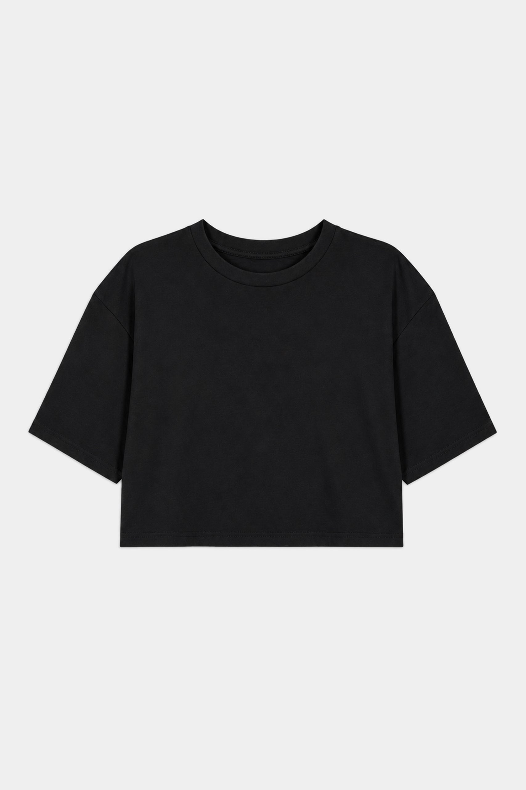 The SPLITS59 Djuna Oversized Crop Jersey Tee in black, made from a soft spandex blend, features short sleeves and is shown laid flat on a white background.