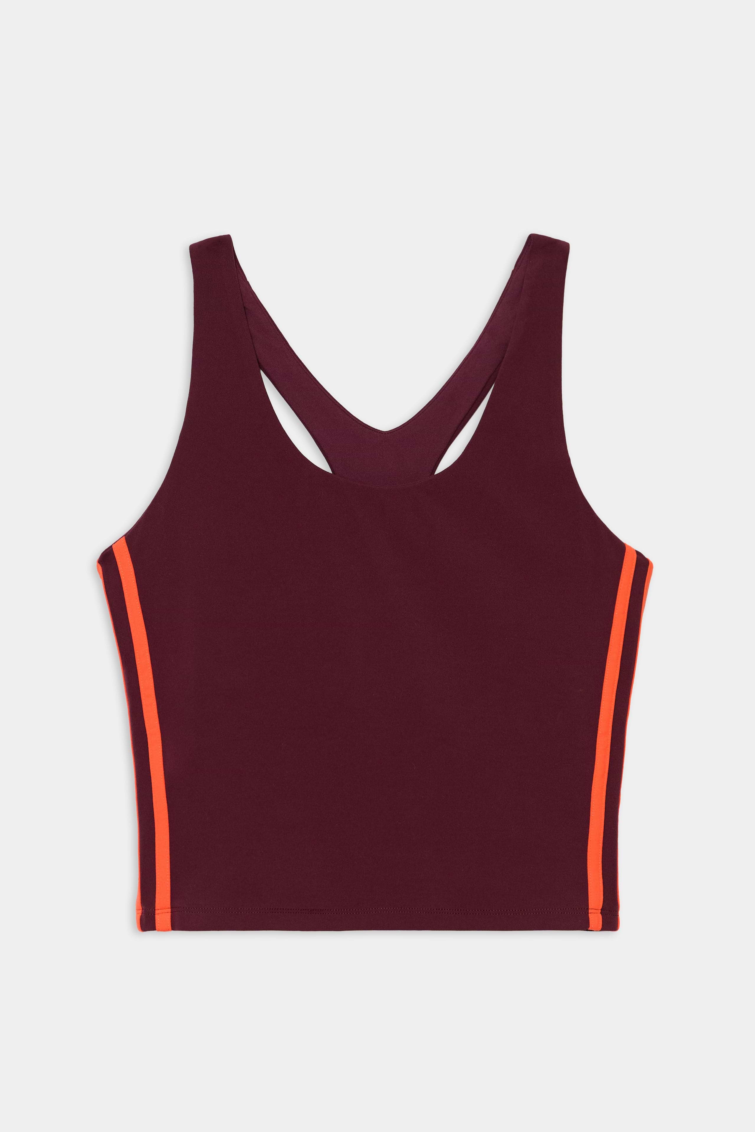 The SPLITS59 Ella Airweight Tank in Dark Cherry/Valencia is a sleeveless racerback crop top with orange side stripes, crafted from a nylon-spandex blend, shown against a white background.