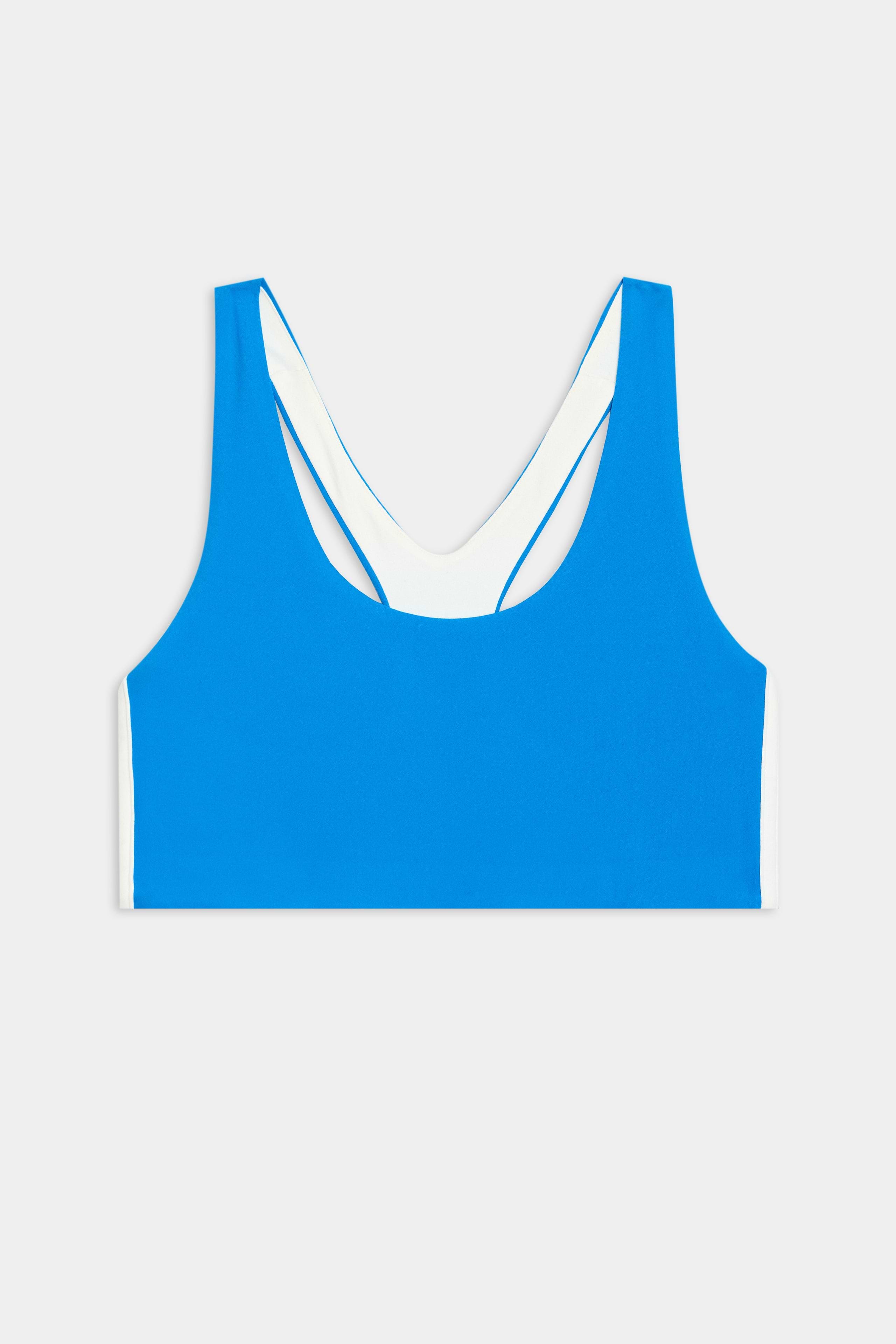 The SPLITS59 Ella Airweight Bra in Riviera/White, featuring a racer back and white inner lining, is ideal for Pilates and shown laid flat against a plain white background.