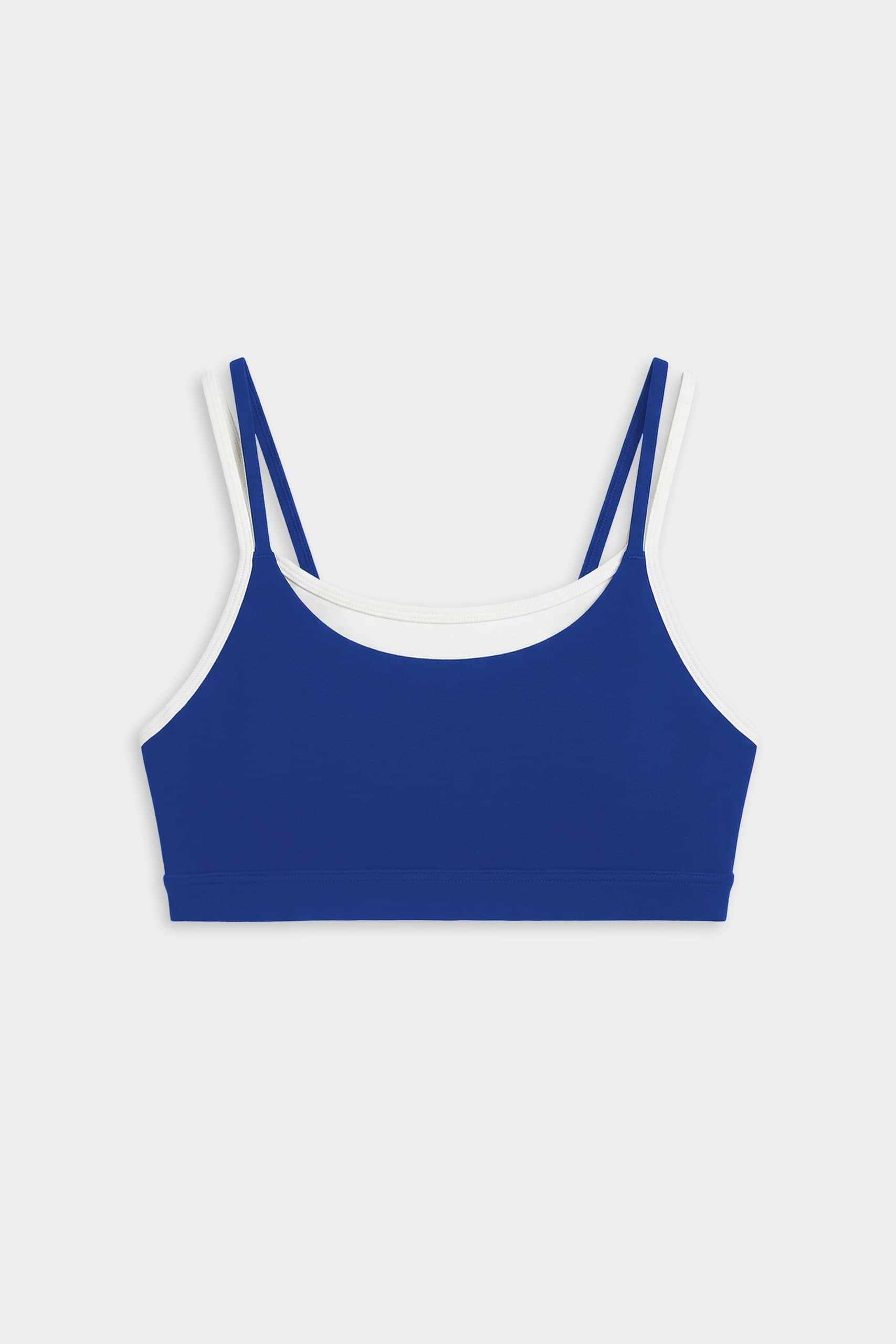 The SPLITS59 Elliah Airweight Double Layer Bra in cobalt with white trim features double shoulder straps and pairs perfectly with your favorite nylon spandex activewear. Displayed on a plain white background.