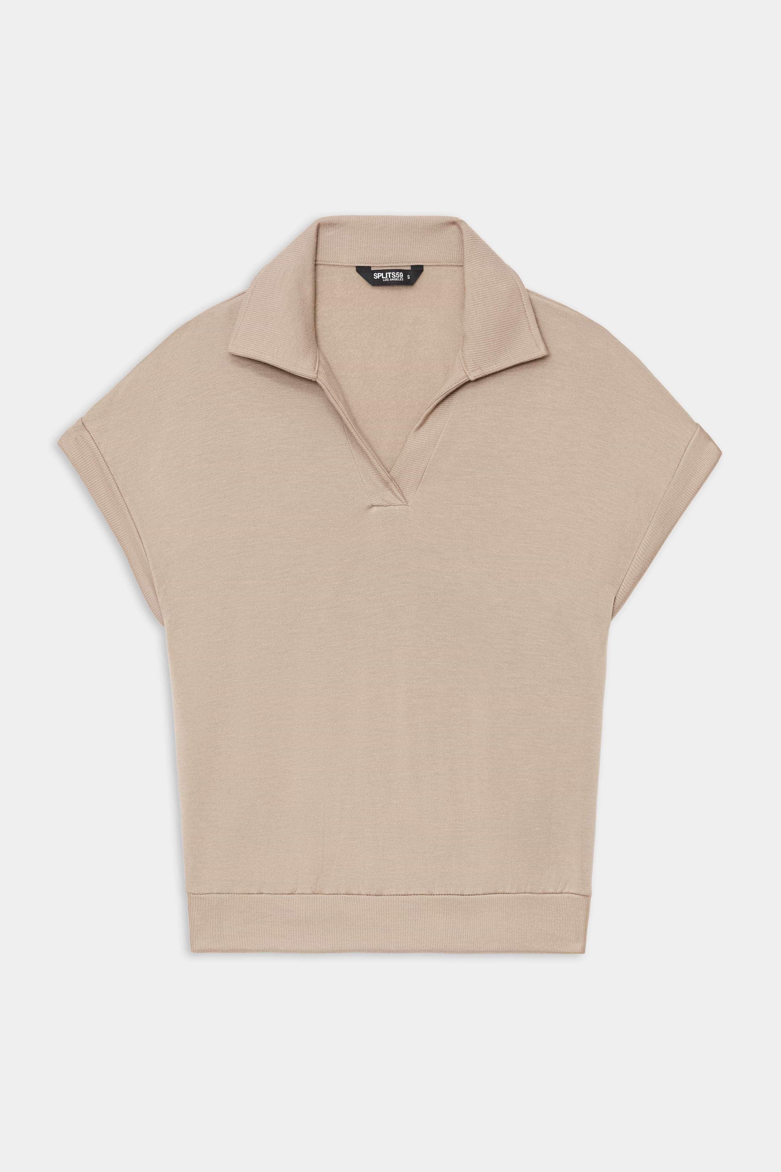 The SPLITS59 Evie Fleece Sleeveless Polo in Latte features a soft fleece fabric, sleeveless design, classic collar, and V-neckline, shown against a white background.