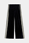 The SPLITS59 Heritage Velour Pant - Black/Creme features soft black velour with creme side stripes, made from a polyester-spandex blend and shown flat on a white background.