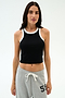 A woman in a SPLITS59 Kiki Rib Crop Tank - Black/White and light gray sweatpants with a "59" graphic stands against a plain white background, ready for gym workouts.