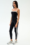 A woman wears the SPLITS59 Monah Rigor Tank in Black/White with matching black leggings featuring a white side stripe and silver athletic shoes—ideal gym attire—set against a plain white background.