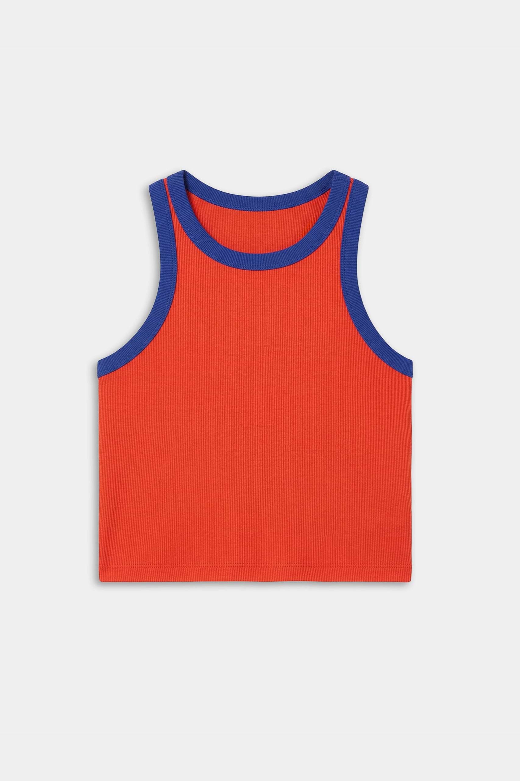 The SPLITS59 Kiki Rib Crop Tank in Lotus Red/Cobalt is a sleeveless, cropped top with blue trim and soft baby rib fabric, shown laid flat on a white background.