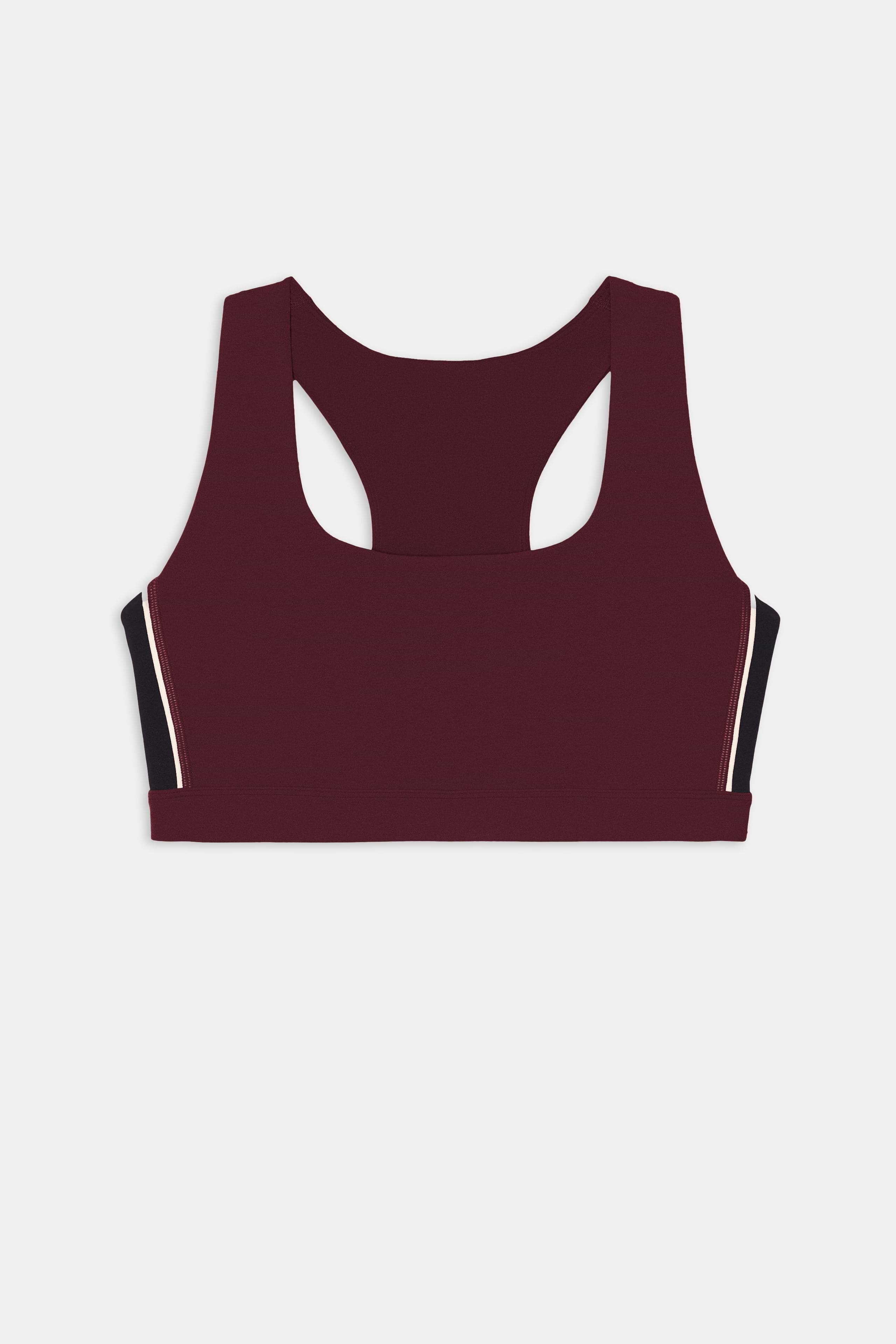 The SPLITS59 Lexi Rigor Bra in Dark Cherry/Black features a maroon racerback design with black and white trim along the sides, crafted from soft nylon spandex fabric and showcased against a white background.