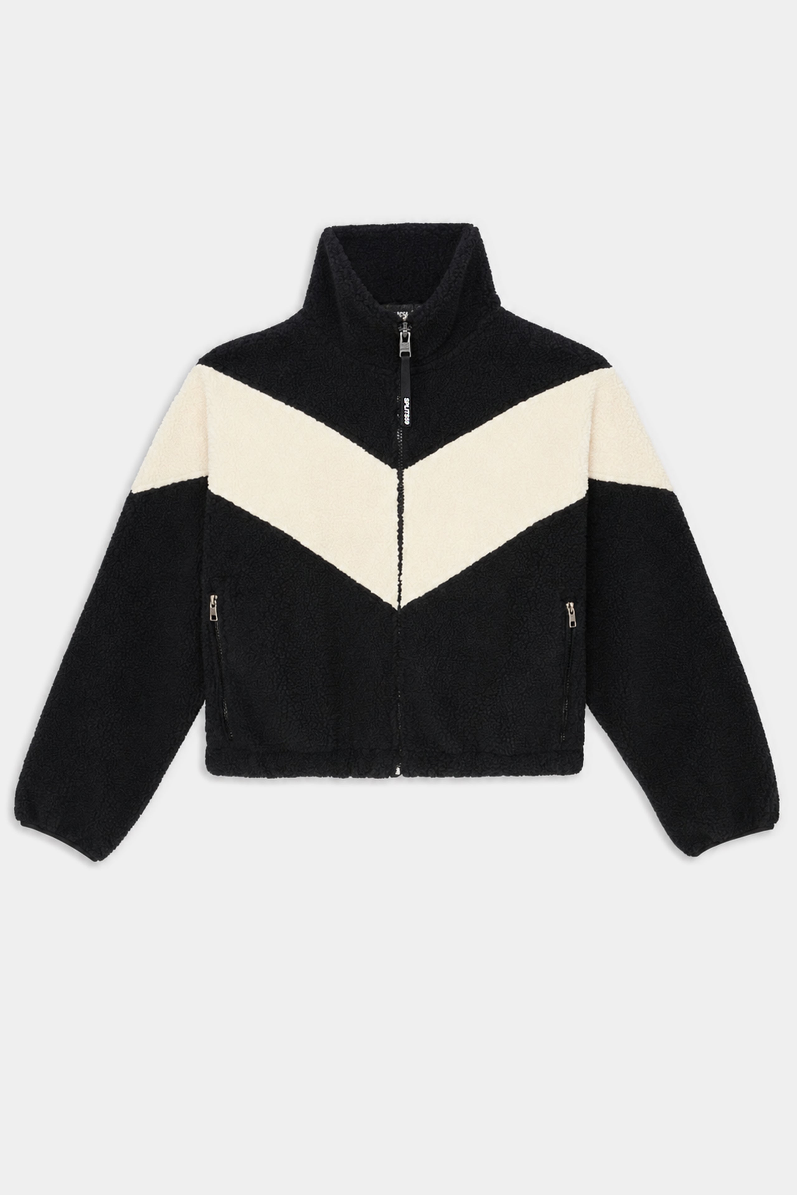 The SPLITS59 Lottie Chevron Sherpa Full Zip Jacket in Black/Creme is crafted from 100% polyester fleece and features a striking white chevron pattern across the chest and arms, along with a high collar, zip front, and convenient side pockets.