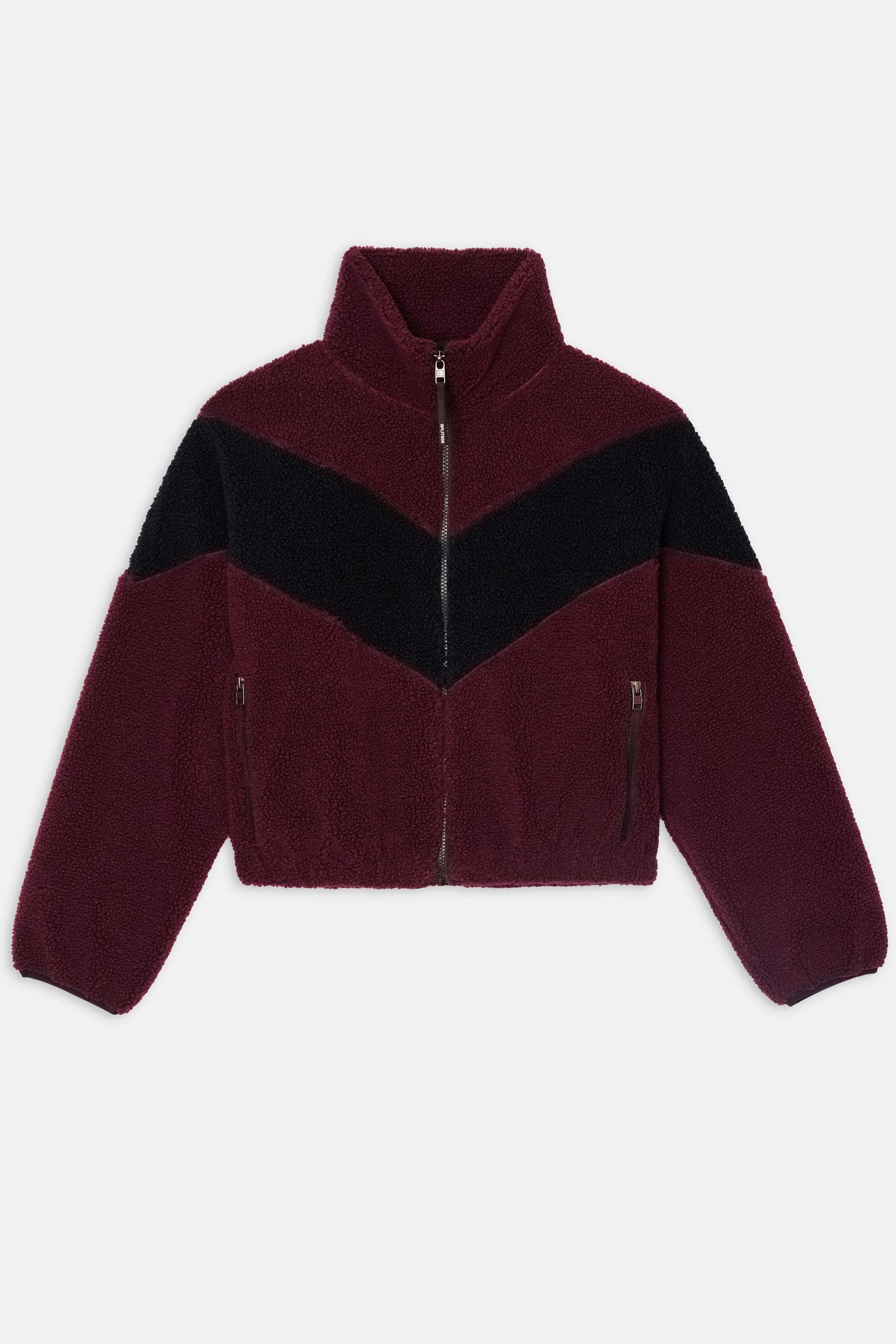 The SPLITS59 Lottie Chevron Sherpa Full Zip Jacket in Dark Cherry/Black is a cropped fleece jacket made from soft 100% polyester, featuring a black chevron stripe across the chest and sleeves, a front zipper, and two zippered pockets.