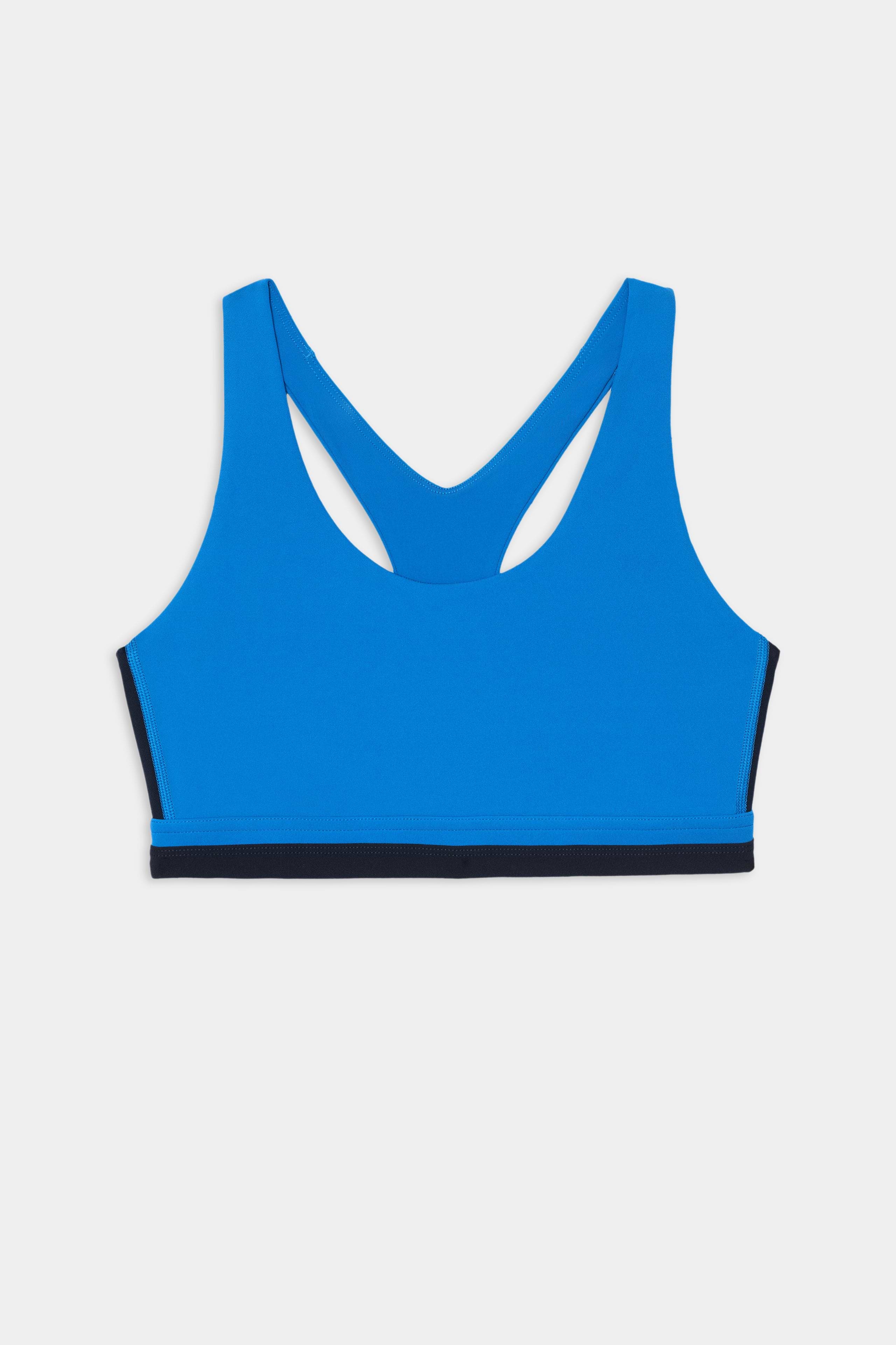 The SPLITS59 Maci Airweight Bra in Classic Blue/Indigo features a racerback design and a black elastic band at the bottom, shown against a white background—a perfect sporty bra for your next workout.