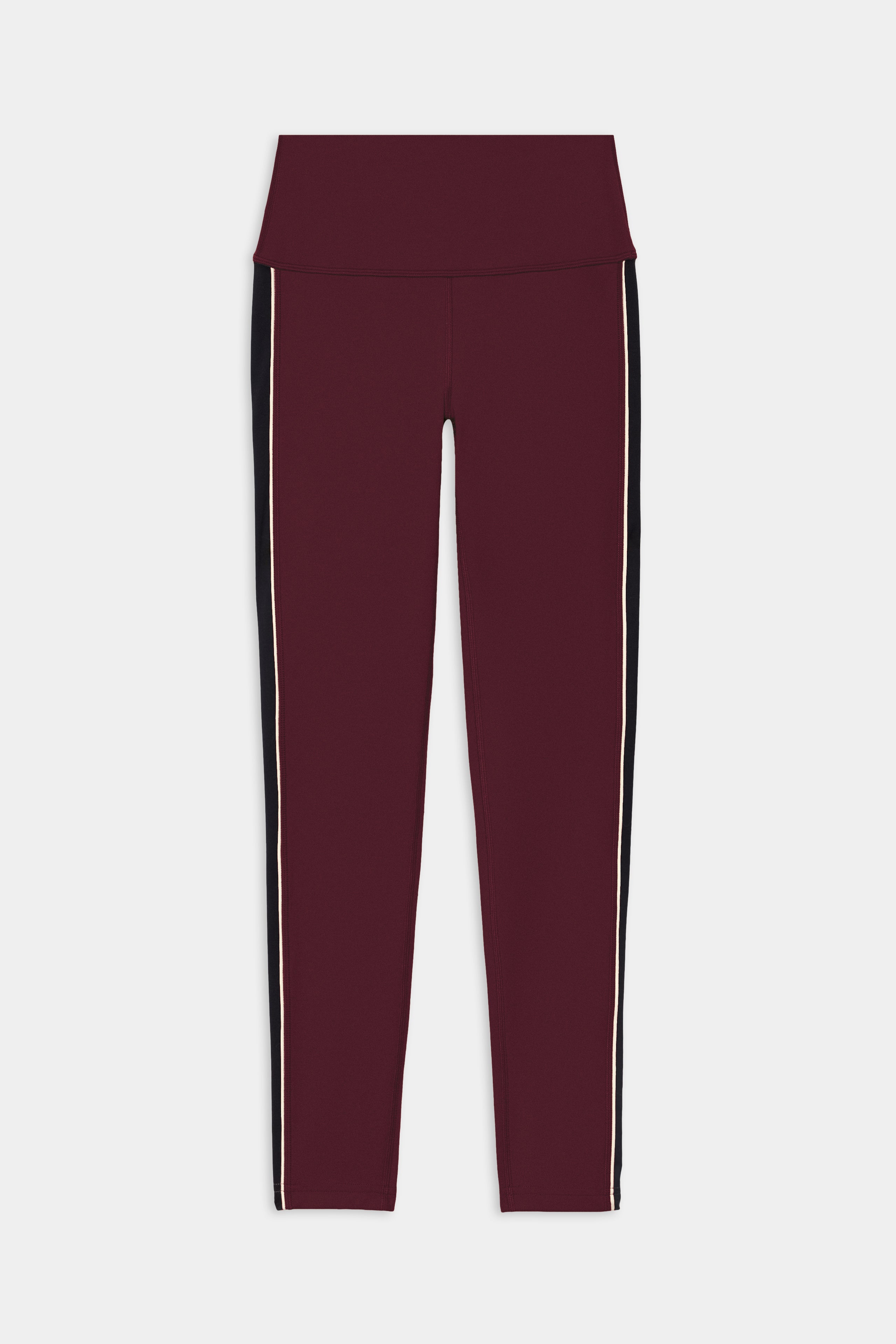 Pair of SPLITS59 Margot Rigor Legging in Dark Cherry/Black, featuring high performance fabric, a high waistband, and vertical black and white side stripes, laid flat on a white background.