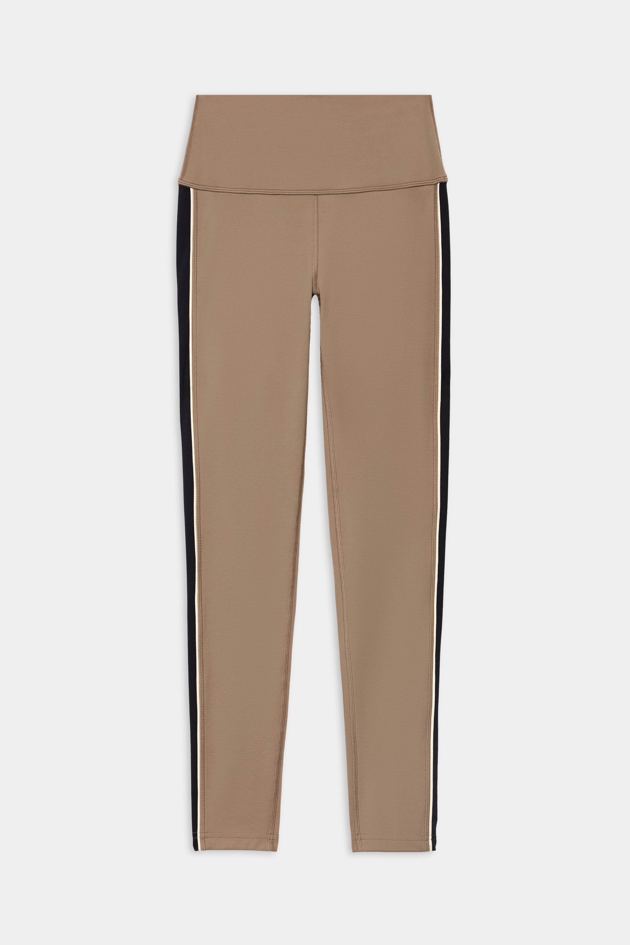 The SPLITS59 Margot Rigor Legging in Lentil/Black is a pair of beige high-waisted leggings crafted from a soft nylon and spandex blend, featuring black and white side stripes, shown laid flat on a white background.