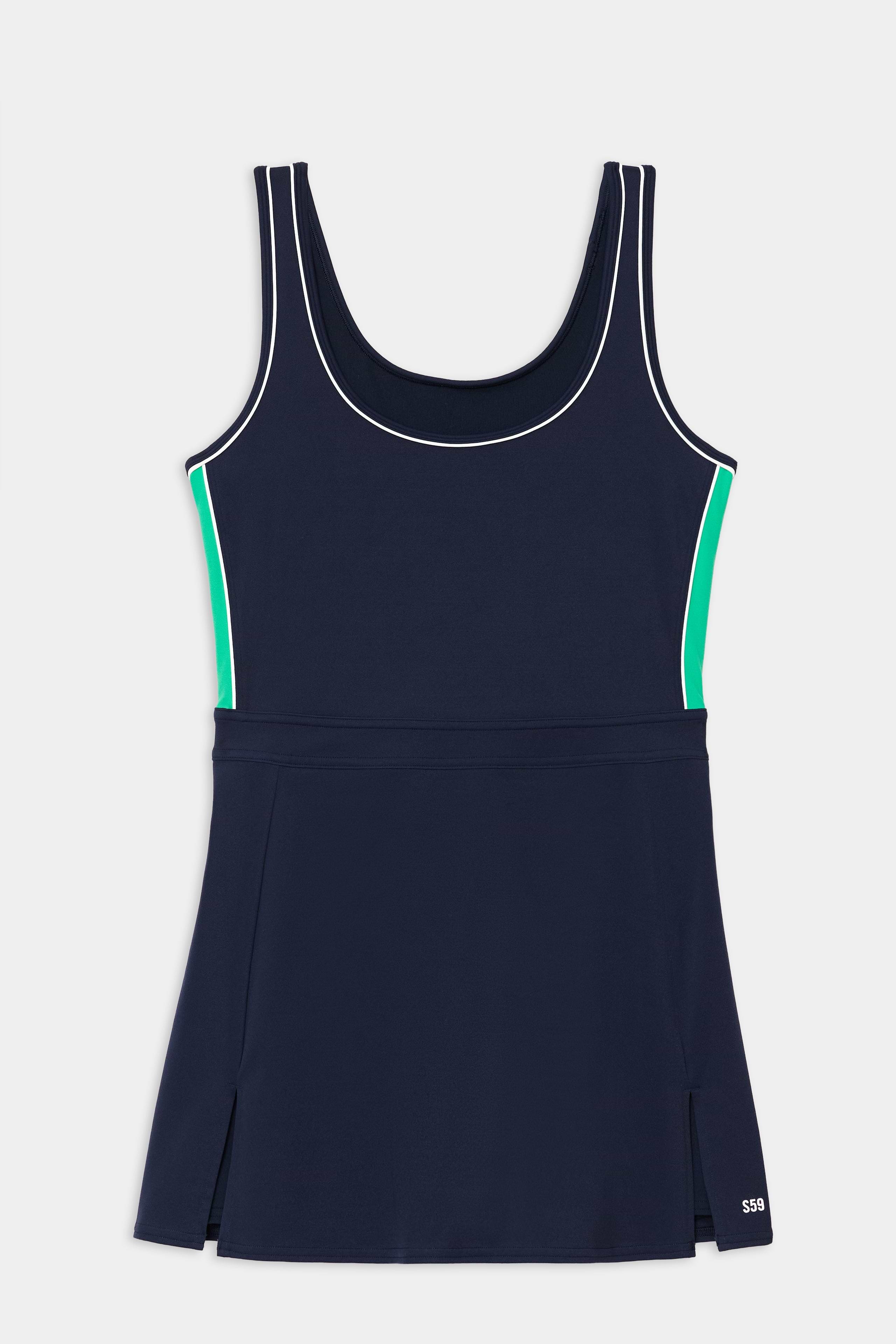 The SPLITS59 Martina Rigor Color Block Dress in Indigo/Spearmint is a sleeveless tennis dress with white piping, green side panels, a fitted bodice, pleated skirt, stretch nylon-spandex fabric, and a small "S19" logo near the hem.
