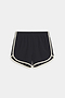 The SPLITS59 Megan Woven Nylon Run Short in Black/Creme features white trim, an elastic waistband, and curved hems in a nylon-spandex blend, shown laid flat on a white background.