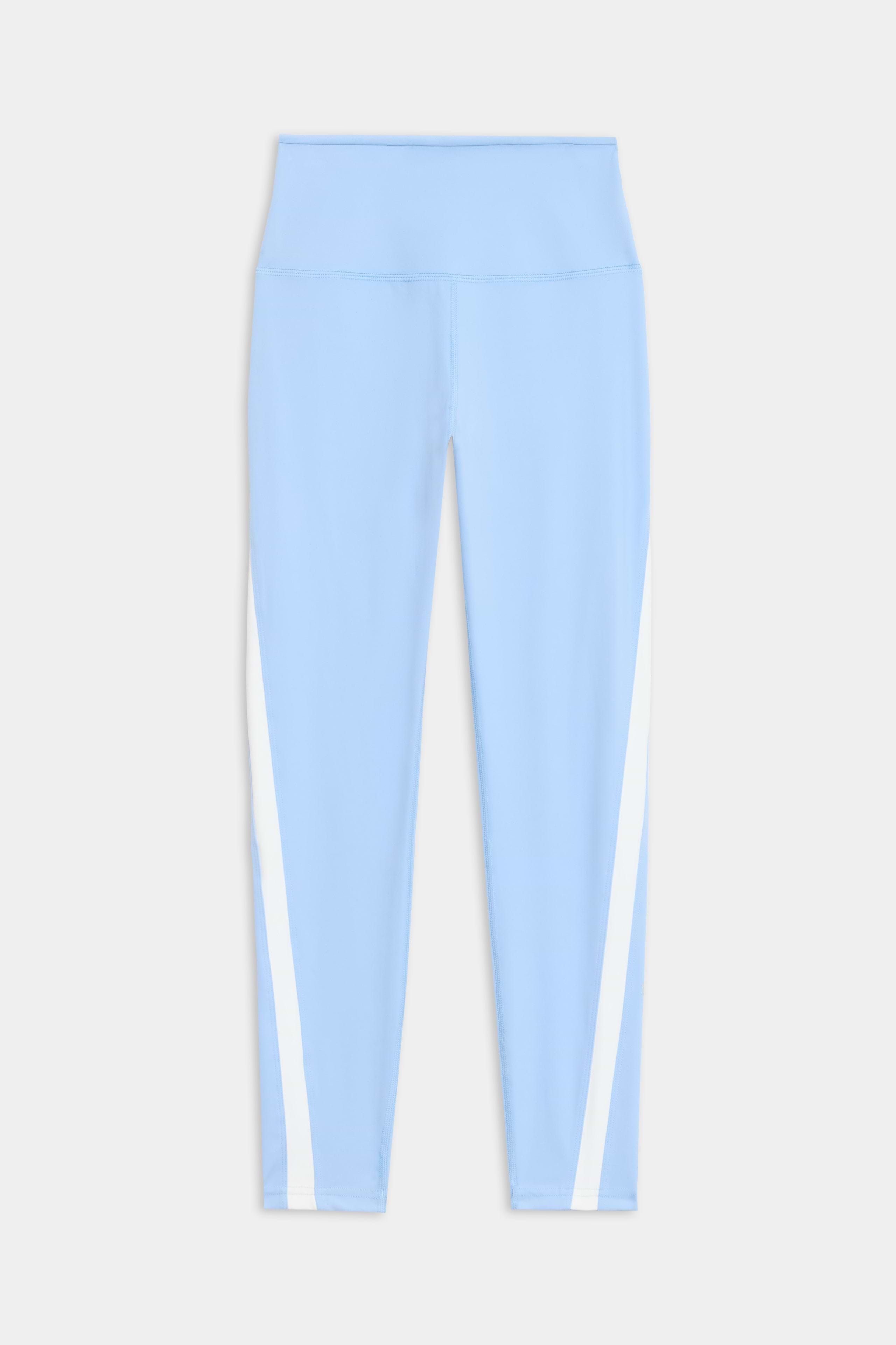 The Miles High Waist Rigor 7/8 leggings by SPLITS59 are light blue with a high waistband and white vertical side stripes, displayed flat against a white background.