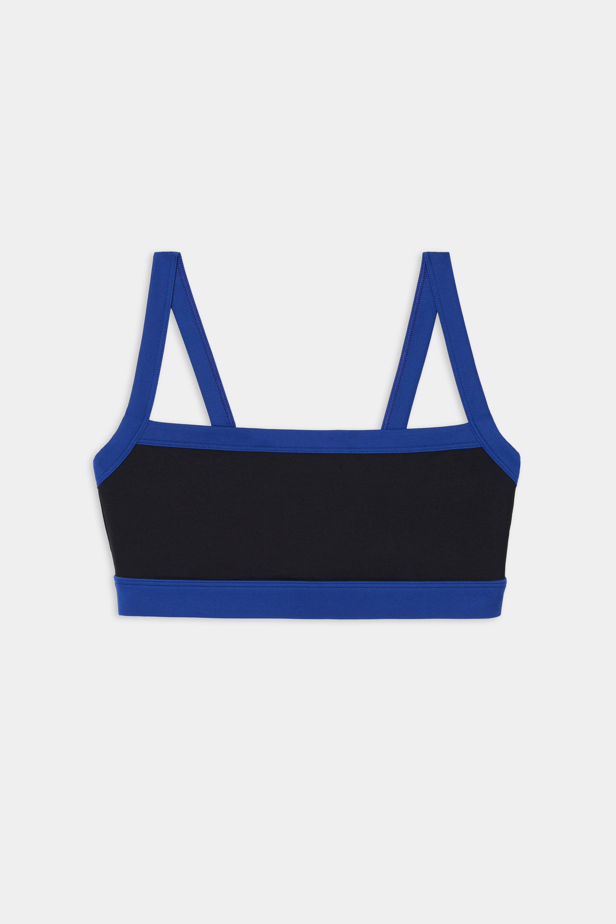 The Monah Rigor Bra - Black/Cobalt by SPLITS59 features double blue straps and blue trim on black, made from stretchy fabric, shown on a plain white background.