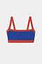 The Monah Rigor Bra - Cobalt/Terracotta by SPLITS59 features blue nylon spandex, wide red straps, and red trim, shown against a white background.