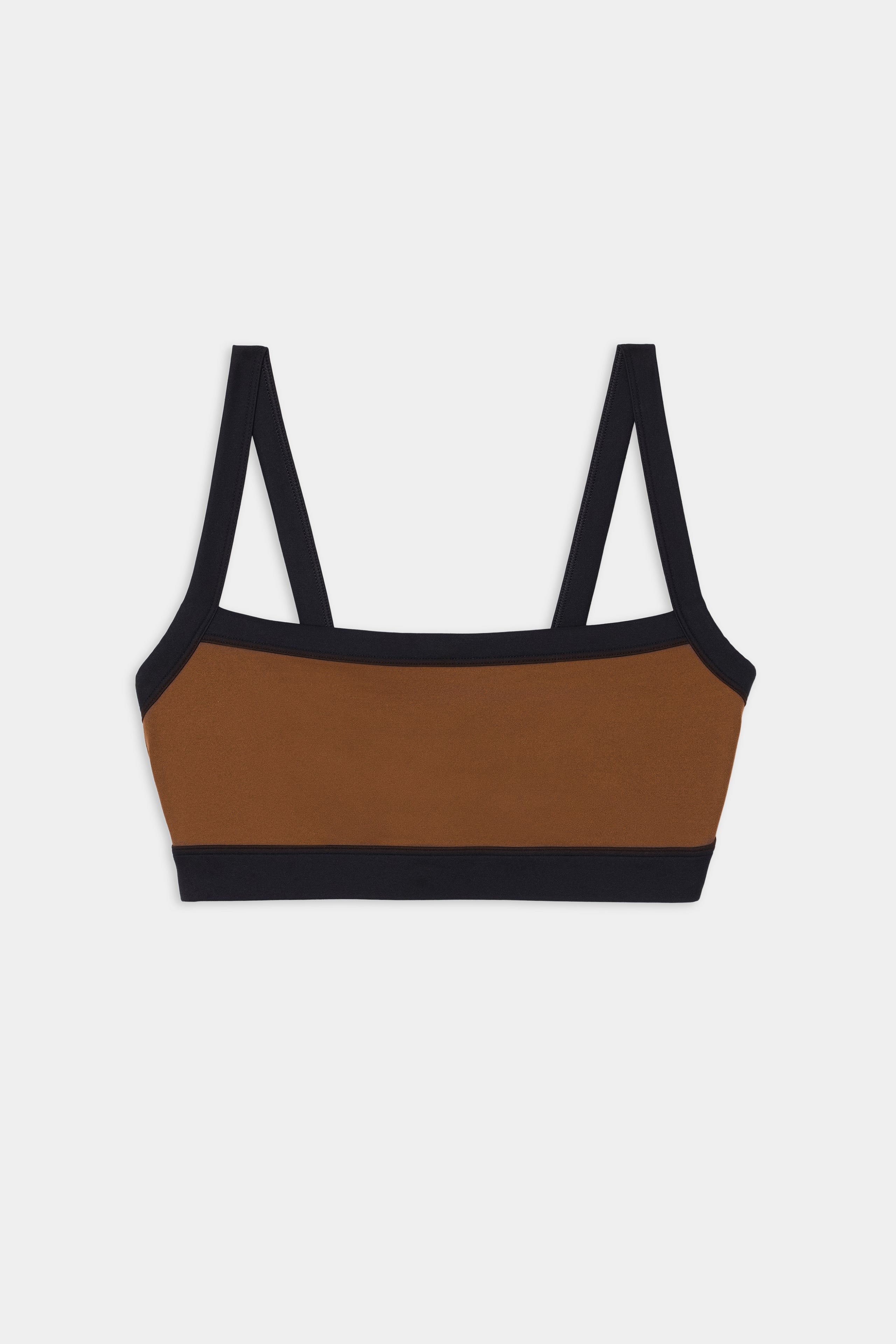 The SPLITS59 Monah Rigor Bra - Toffee/Black features black trim and straps, made from a nylon-spandex blend, shown flat on a white background.