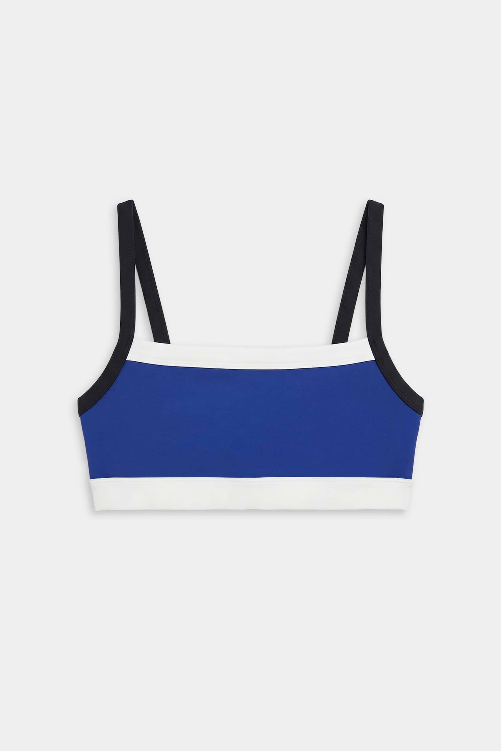 The SPLITS59 Monah Rigor Bra - Cobalt/Black features a blue base with black straps and white trim, showcased against a white background.
