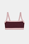 The SPLITS59 Monah Rigor Bra in Dark Cherry/Blush features a color-blocked design with a dark maroon front panel and light pink straps, trim, and band, shown against a plain white background.