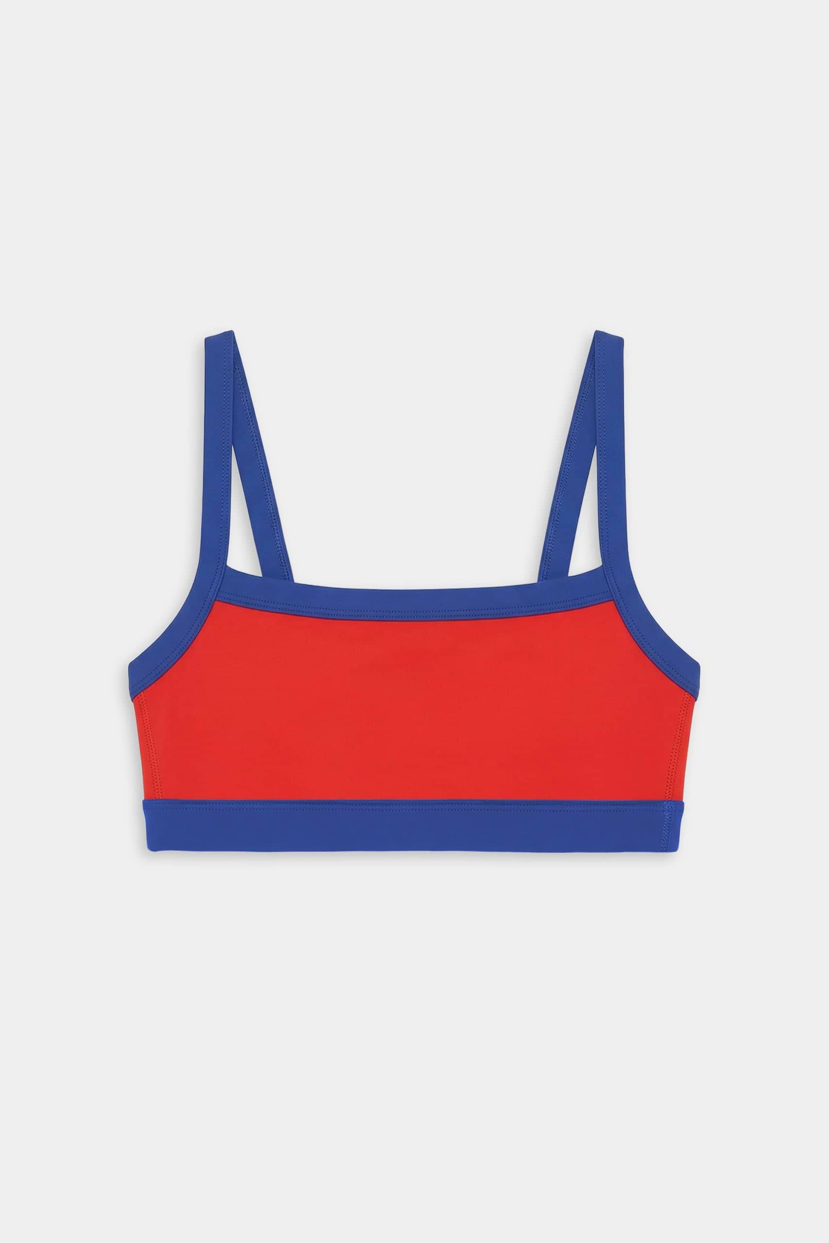 The SPLITS59 Monah Rigor Bra in Lotus Red/Cobalt features blue straps and trim, shown against a plain white background.